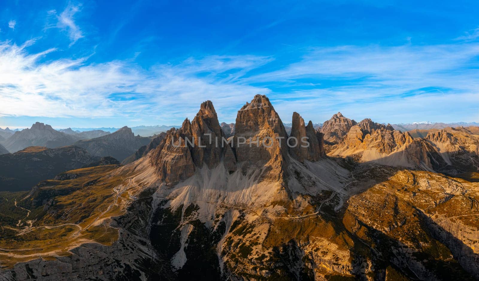 The rocky peaks of Tre Chime di Lavaredo sunset. The edges of the high peaks lighted by the rays of the sun