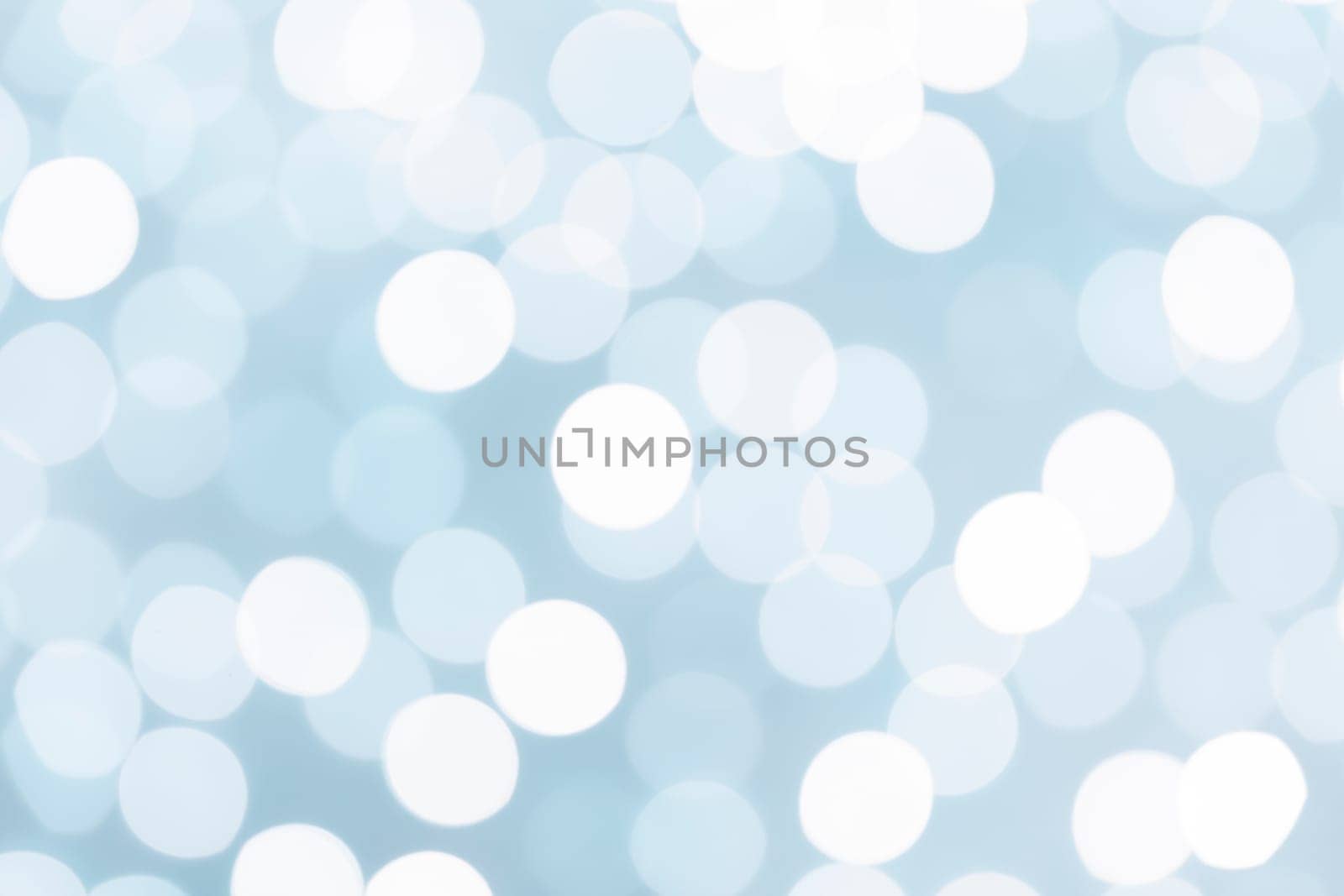 The Light blue glitter festive abstract background with bokeh lights. by Gamjai