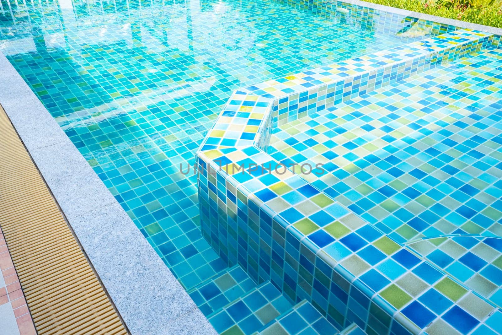 The Macro from Swimming pool with clear blue water in a garden area, surrounded by plants by Gamjai