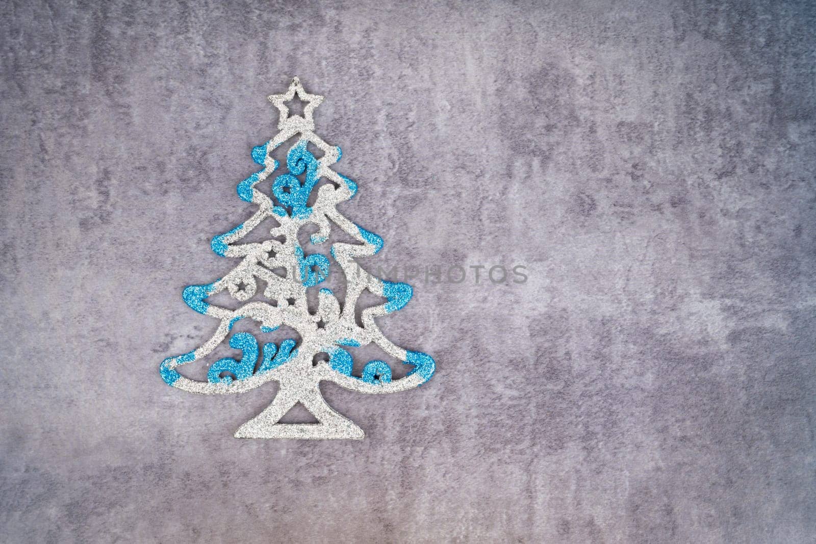 A Christmas tree for decoration on dark wall with empty space. by Gamjai