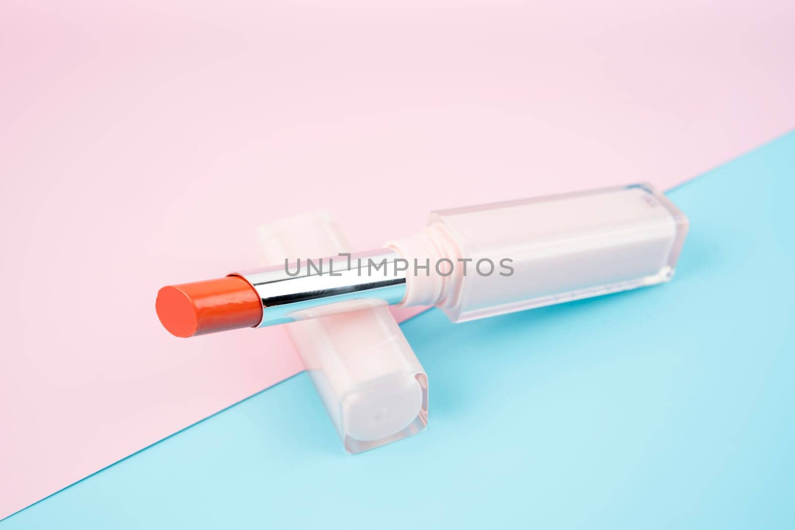 Bright lipstick on colorful background. Professional makeup product.
