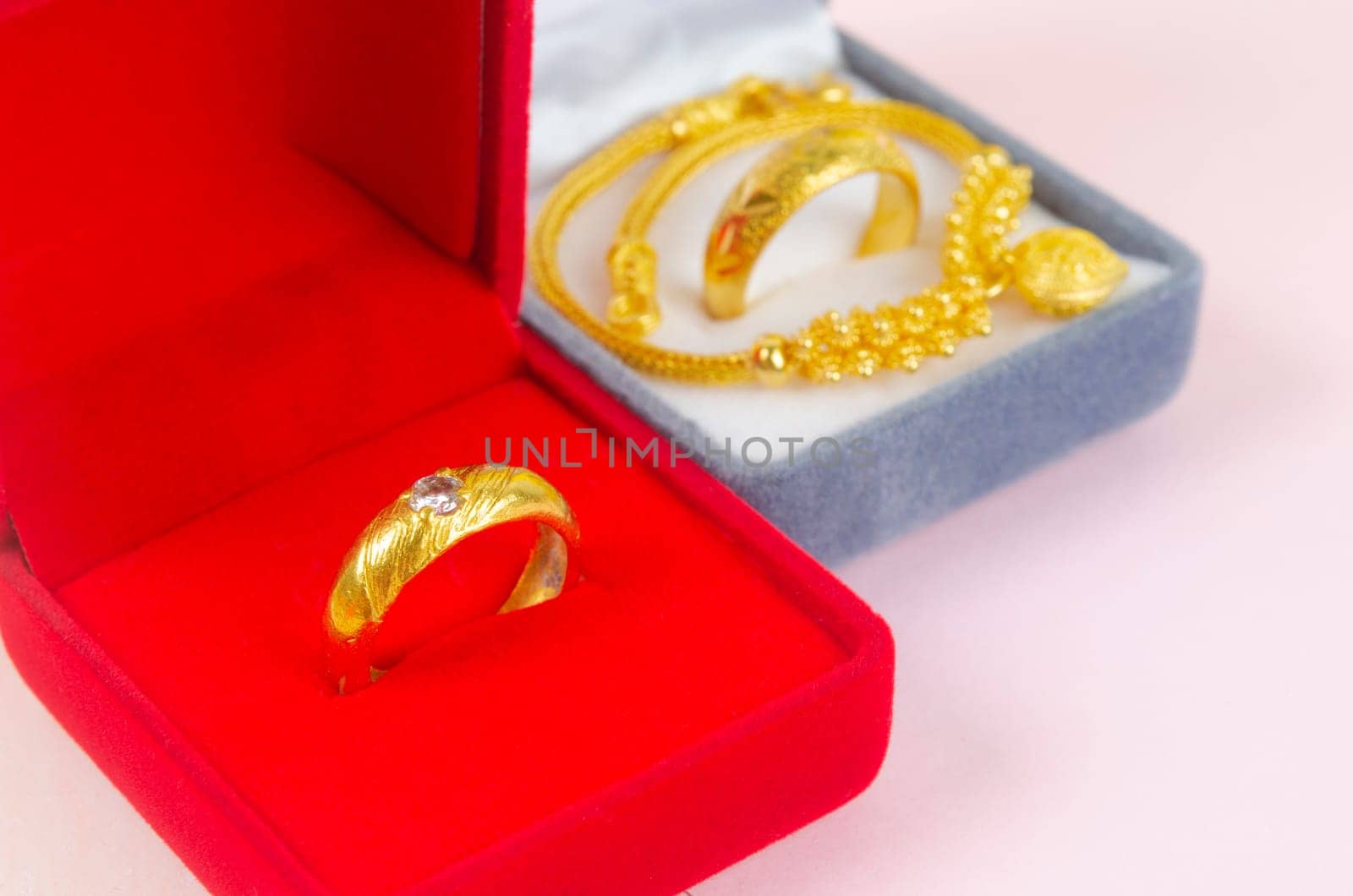 The Gold ring on red velvet box. by Gamjai