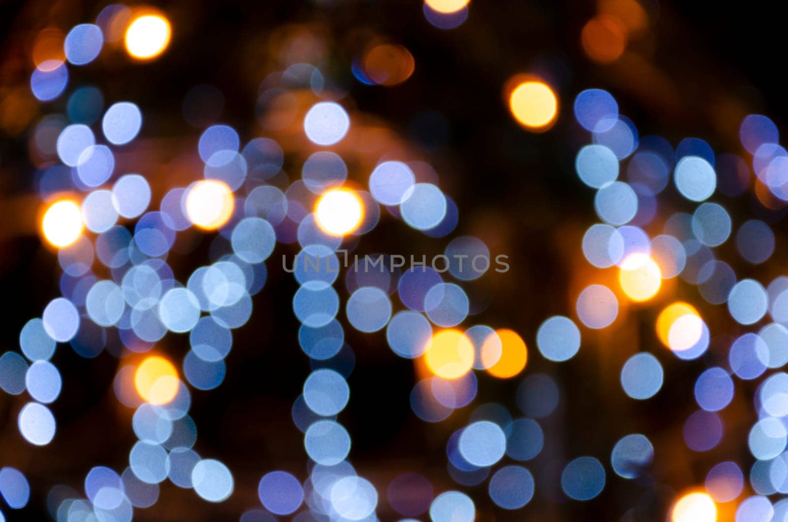 The Abstract image of city lights in the night. by Gamjai