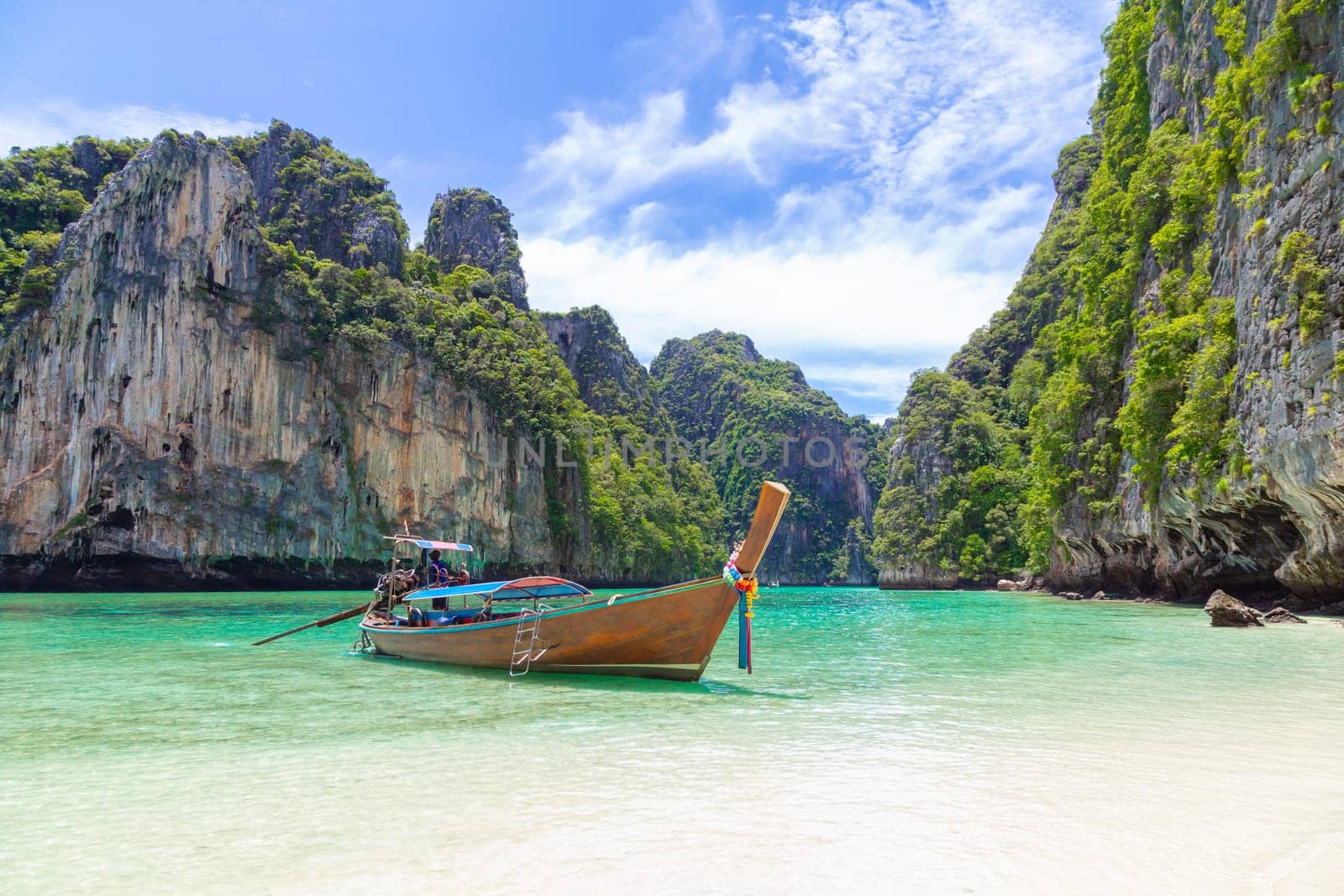 The Thai traditional wooden longtail boat and beautiful beach in Phuket province, Thailand. by Gamjai