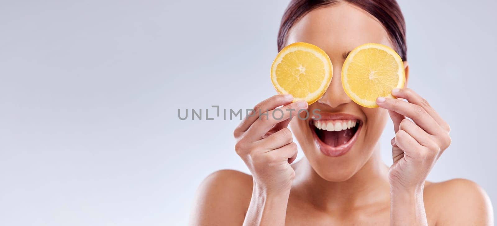Skincare, mockup or happy woman with orange as natural facial with citrus or vitamin c for wellness. Studio background, smile or healthy girl model smiling with organic fruits for dermatology beauty by YuriArcurs