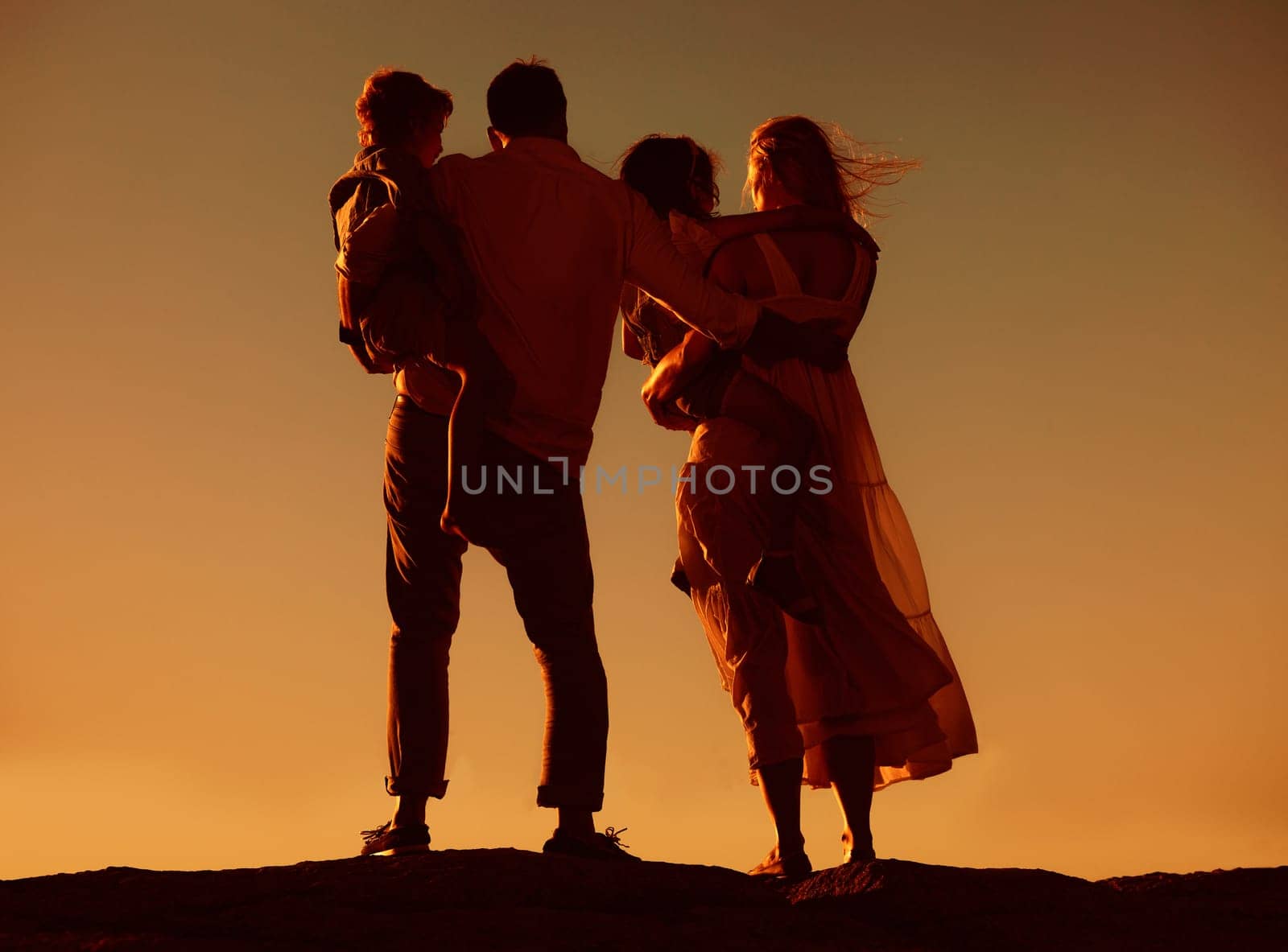 Parents, children and silhouette on mountain, sunset and hug with love, care and summer adventure. Mother, father and young kids with sky background, bond and outdoor on holiday, vacation or journey by YuriArcurs