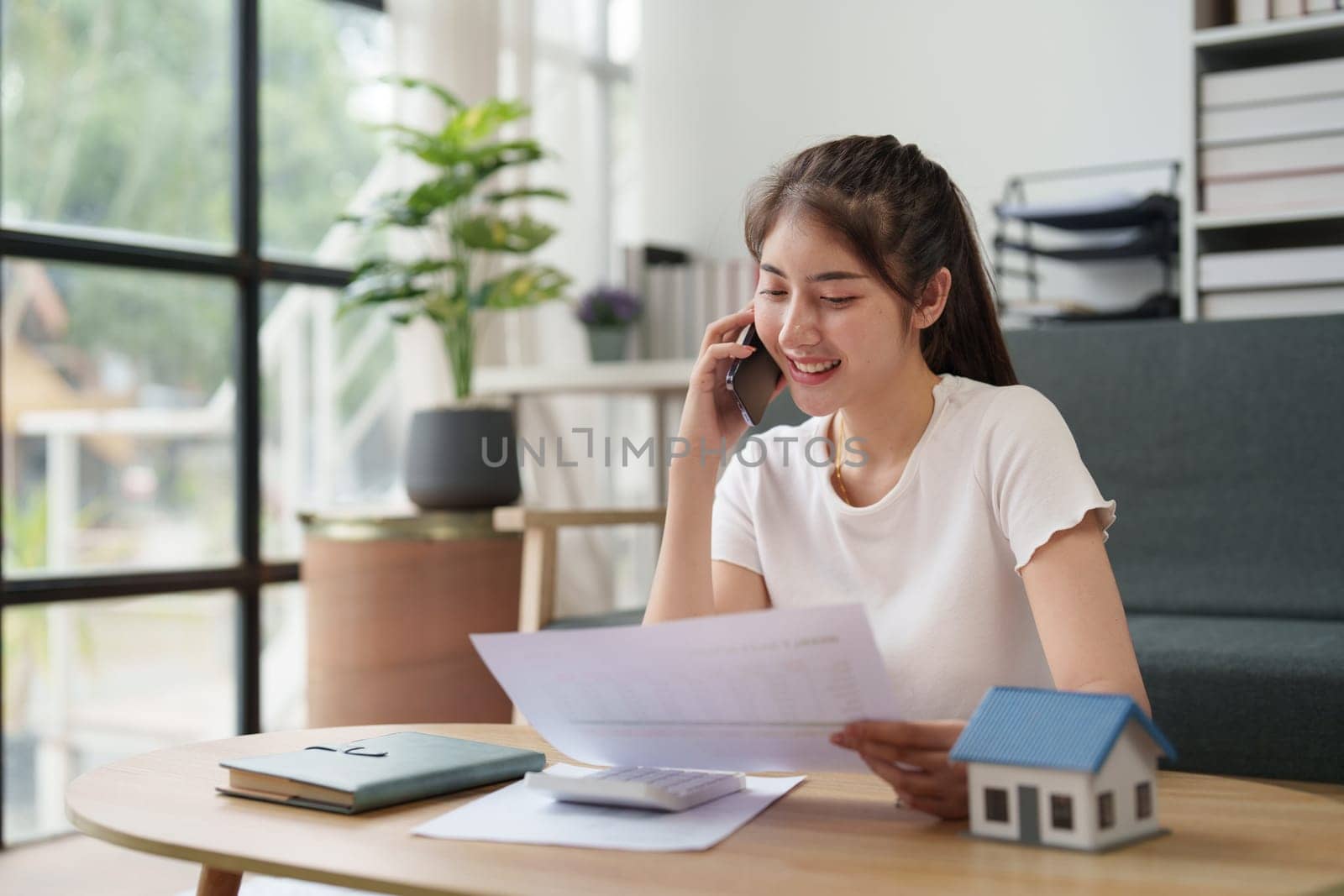 Asian accounting professional calculating household bills, reviewing and analyzing household bills, and filing tax returns.