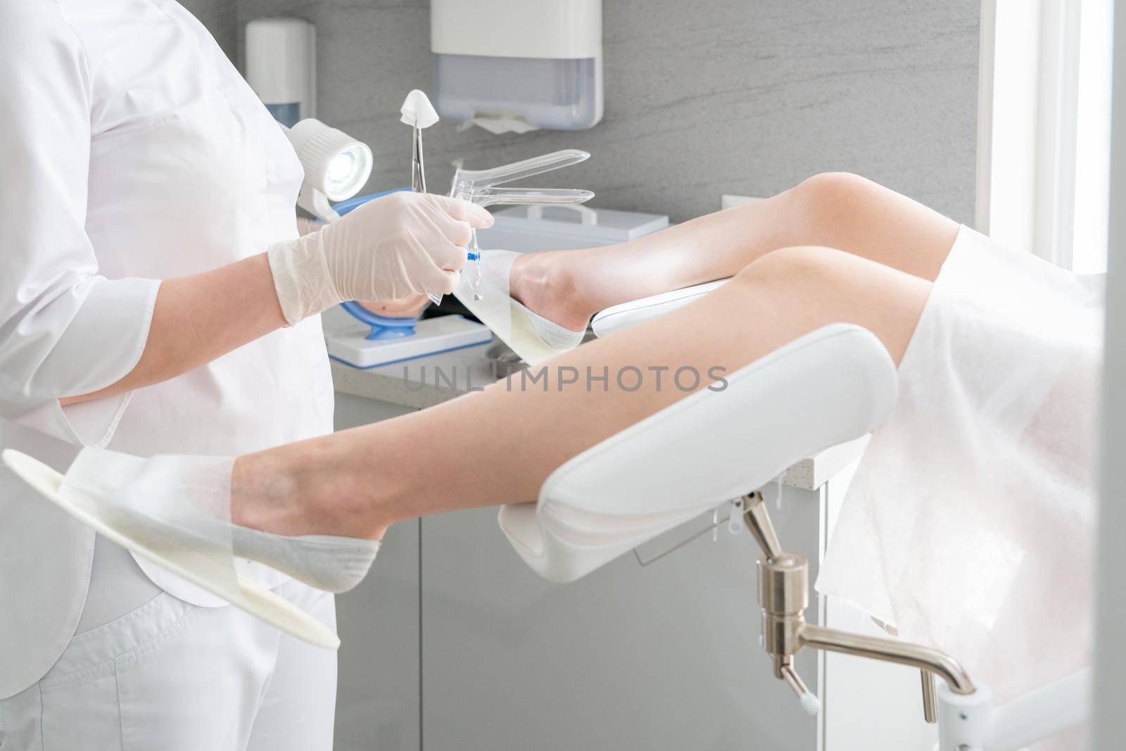Female gynecologist with vaginal speculum in clinic