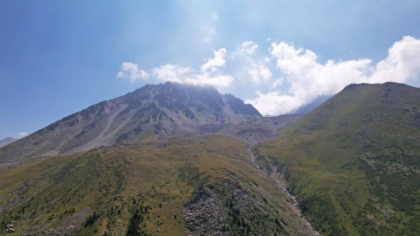 Clouds flow around the tops of high mountains. by Passcal