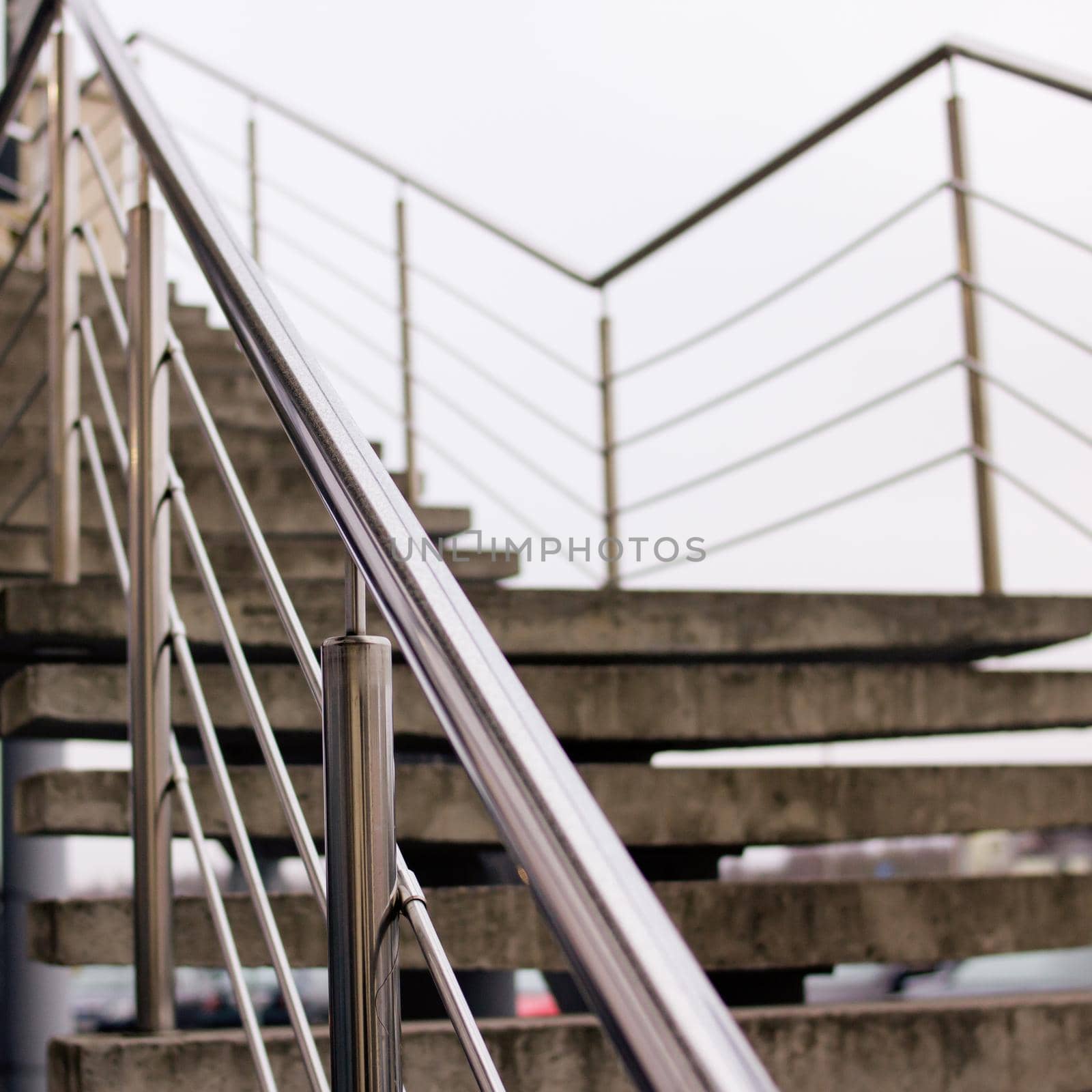 Staircase with metal railing on the sky background