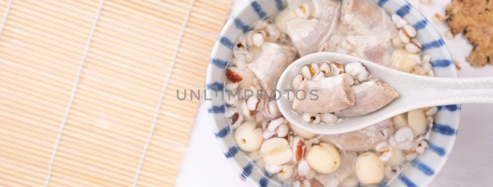 Tasty Four Tonics Herb Flavor Soup,Taiwanese traditional food with herbs,pork intestines on white wooden table,close up,flat lay,top view