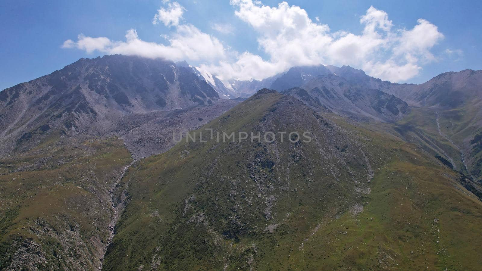 Clouds flow around the tops of high mountains. by Passcal