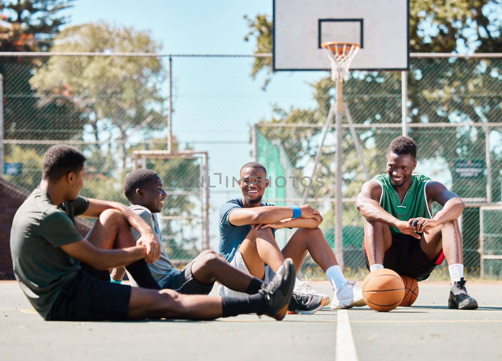 Basketball court, friends and men, break and team sports, social conversation and relax in community playground. Basketball players, rest and black people together after game, team training and match.