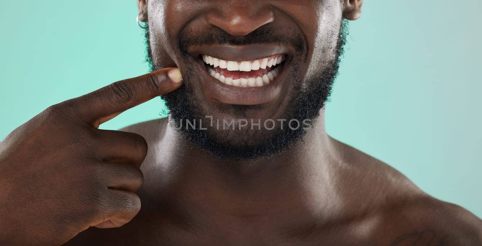 Mouth, dental and teeth with a black man in studio on a blue background for oral hygiene at the dentist. Healthcare, insurance and whitening with a male touching his face or cheek for health.