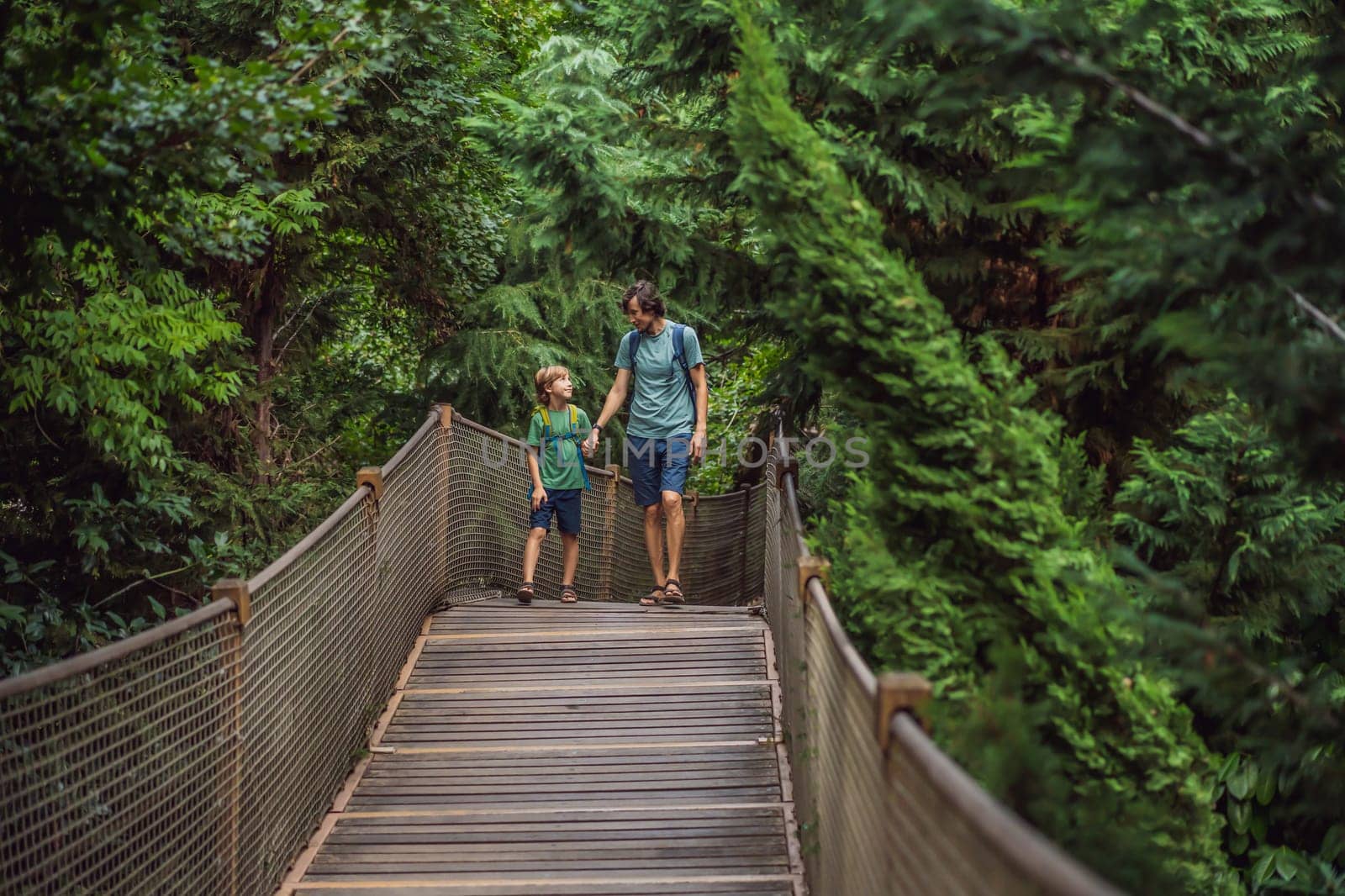 father and son tourists in Rope bridge in Yildiz Park. Besiktas, Istanbul, Turkey. Turkiye. Traveling with kids concept.