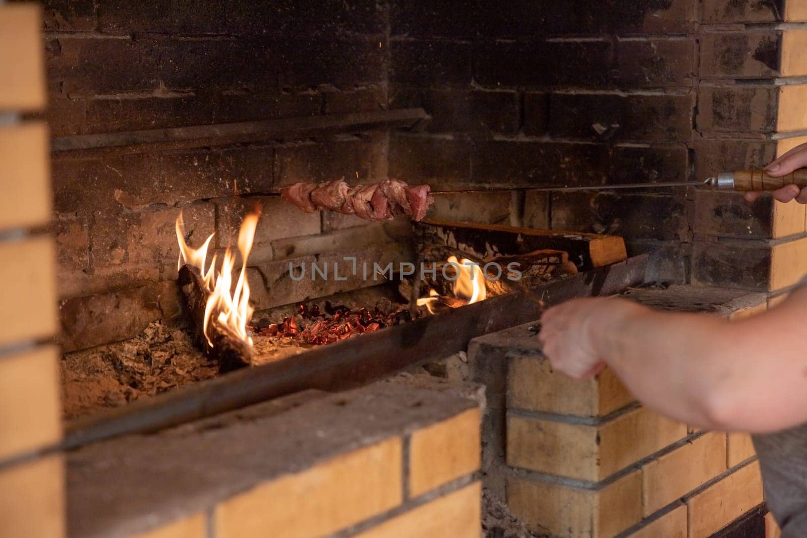 Marinated shashlik preparing on a barbecue grill over charcoal. Shashlik or Shish kebab popular in Eastern Europe.