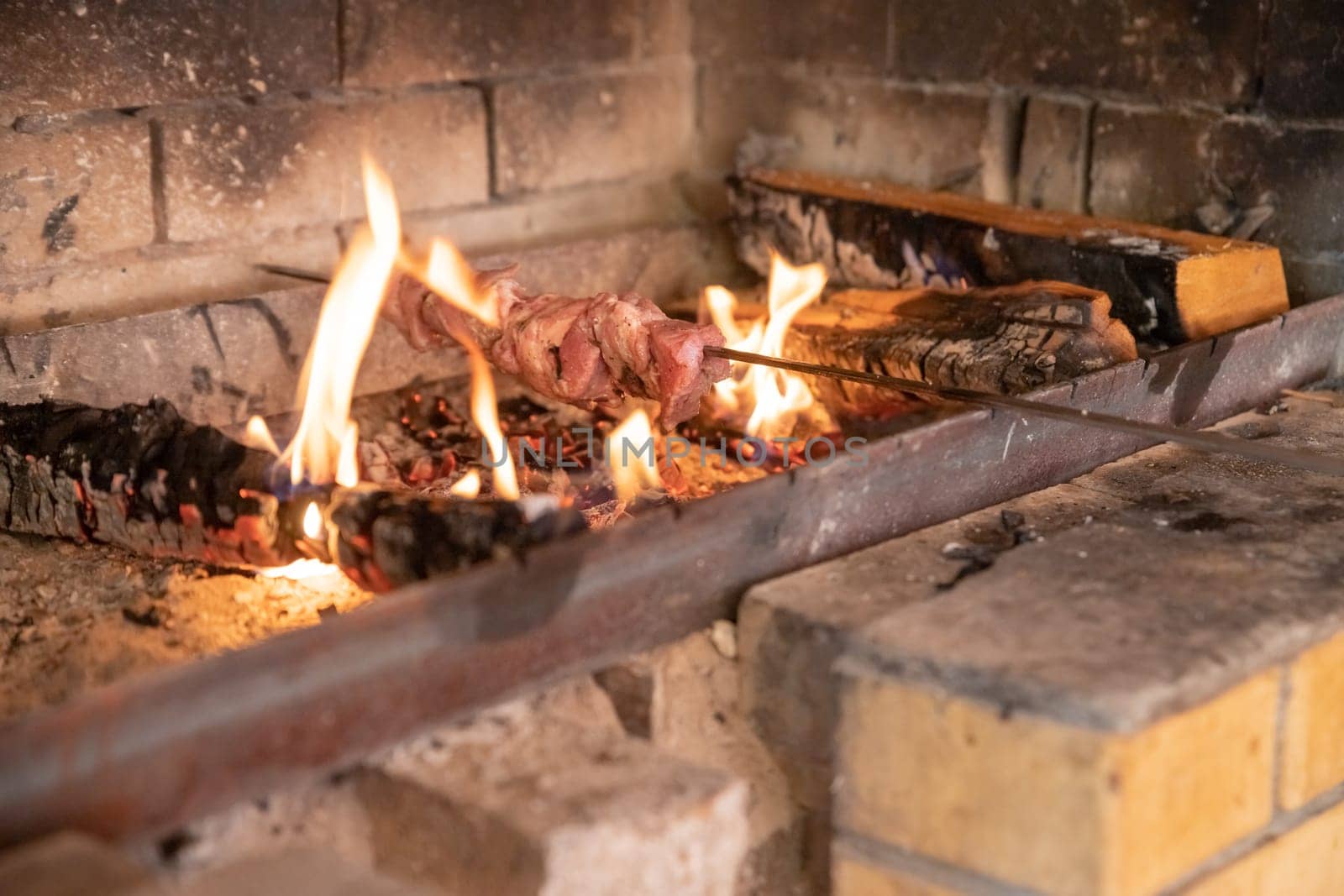 Marinated shashlik preparing on a barbecue grill over charcoal. Shashlik or Shish kebab popular in Eastern Europe.