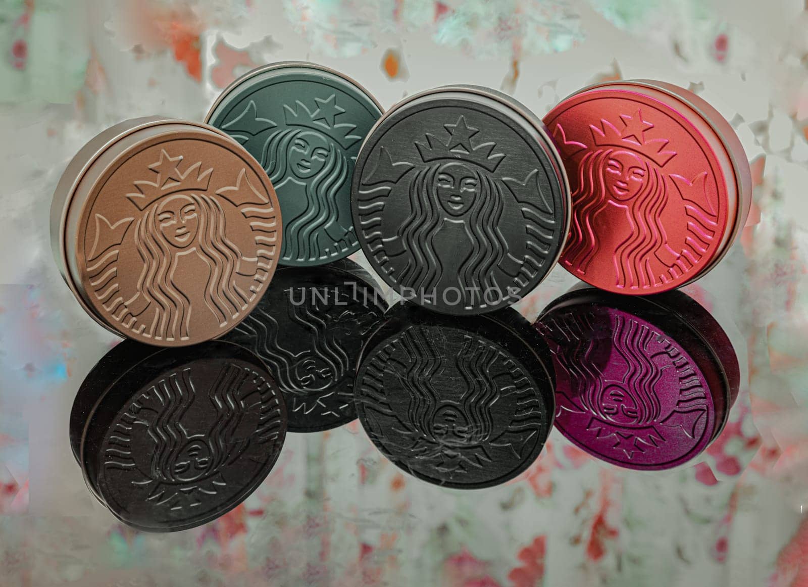 Bangkok, Thaiand May 5, 2023 - The Colorful of Metal round boxes on floral patterned curtains background. Which are the Collection Series of Starbucks. They are for keeping snacks or some accessories which are reflected. Space for text,