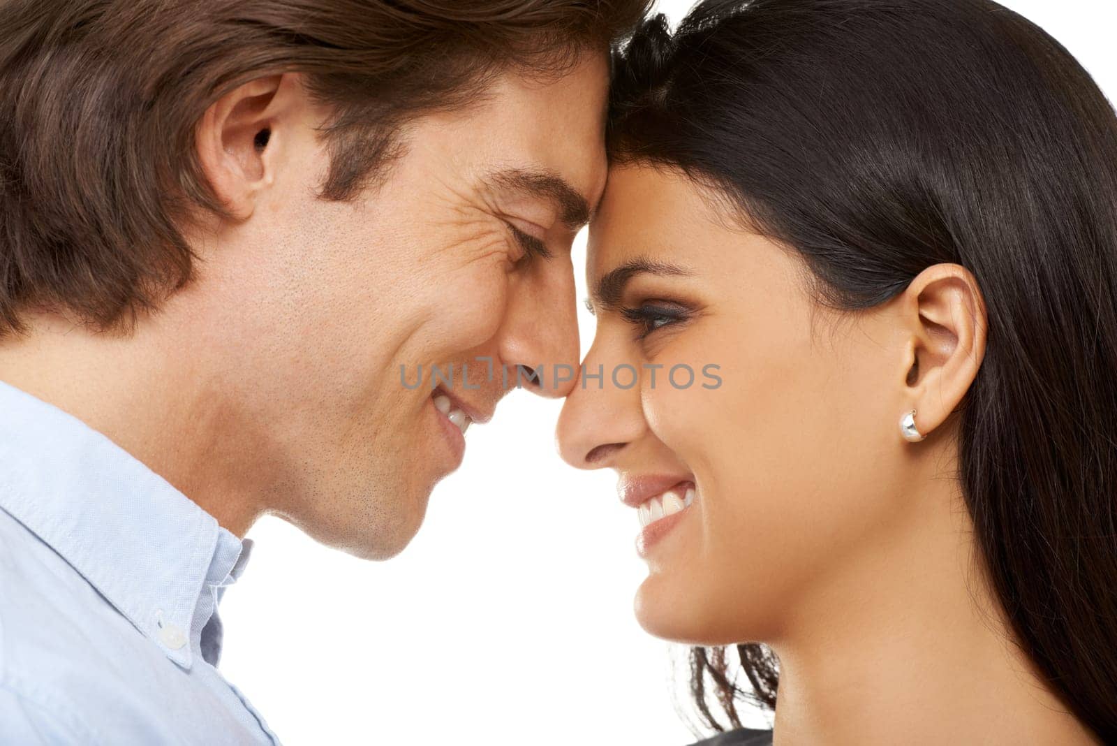Couple, forehead and smile for love, valentines day or date in affection isolated against white studio background. Closeup of man and woman smiling touching heads embracing special month of romance.