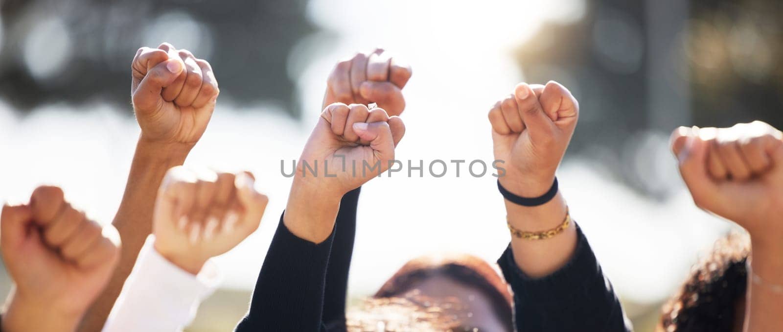 Closeup, group and protest with solidarity, hands and support for human rights, equality or freedom. Zoom, community or protesters with teamwork, activism or union with empowerment, outdoor and crowd.