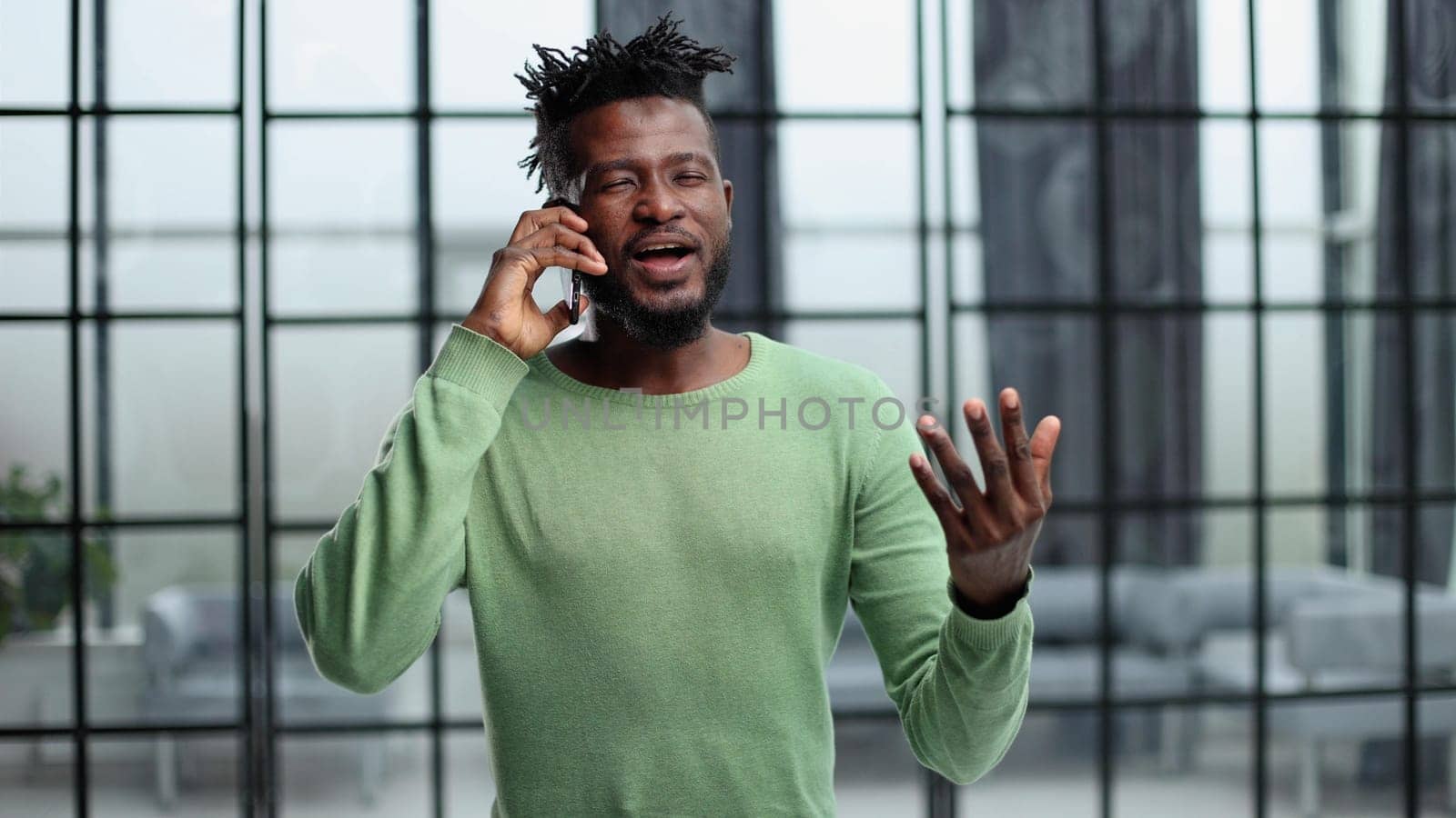 Businessman in office. Handsome man talking on phone at work.