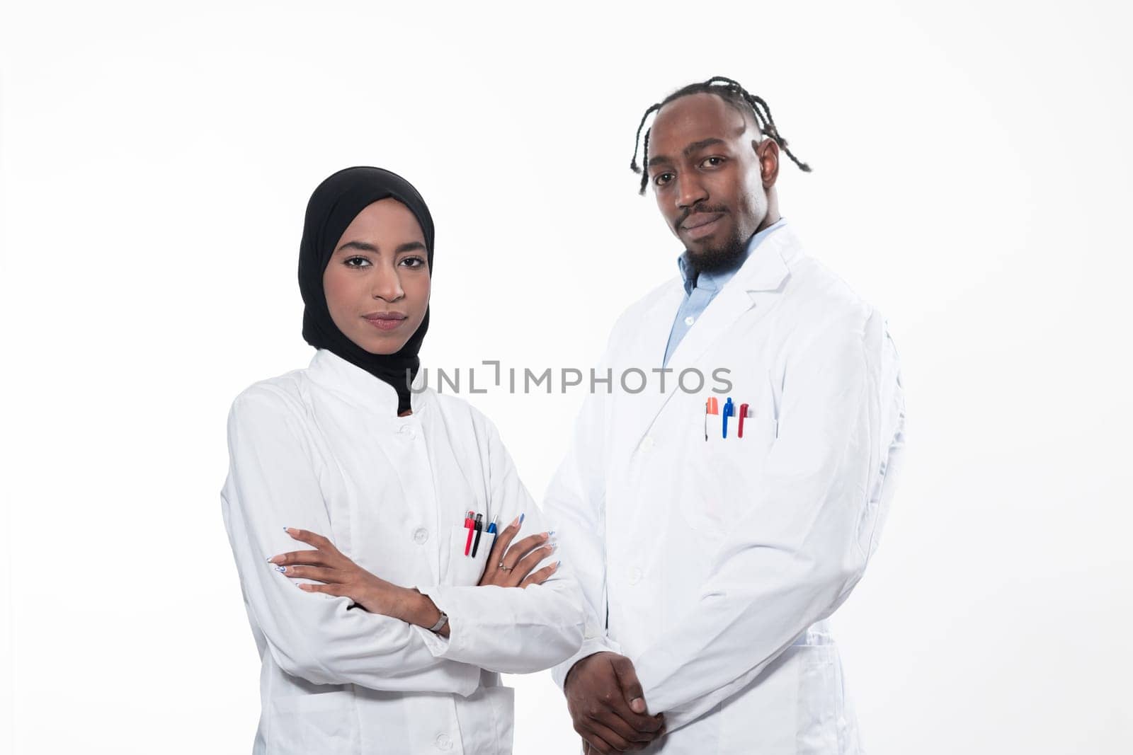 Closeup front view of group of mixed age doctors and nurses standing side by side and looking at the camera. Young Middle Eastern female in a team with African American black doctor. High quality photo