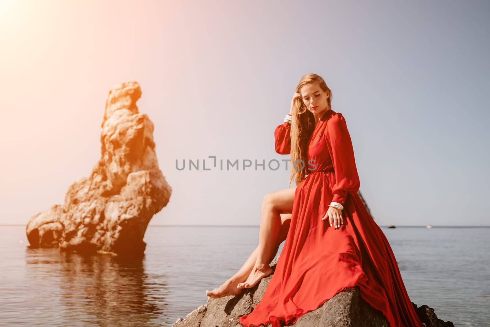 Woman travel sea. Happy tourist taking picture outdoors for memories. Woman traveler looks at the edge of the cliff on the sea bay of mountains, sharing travel adventure journey.