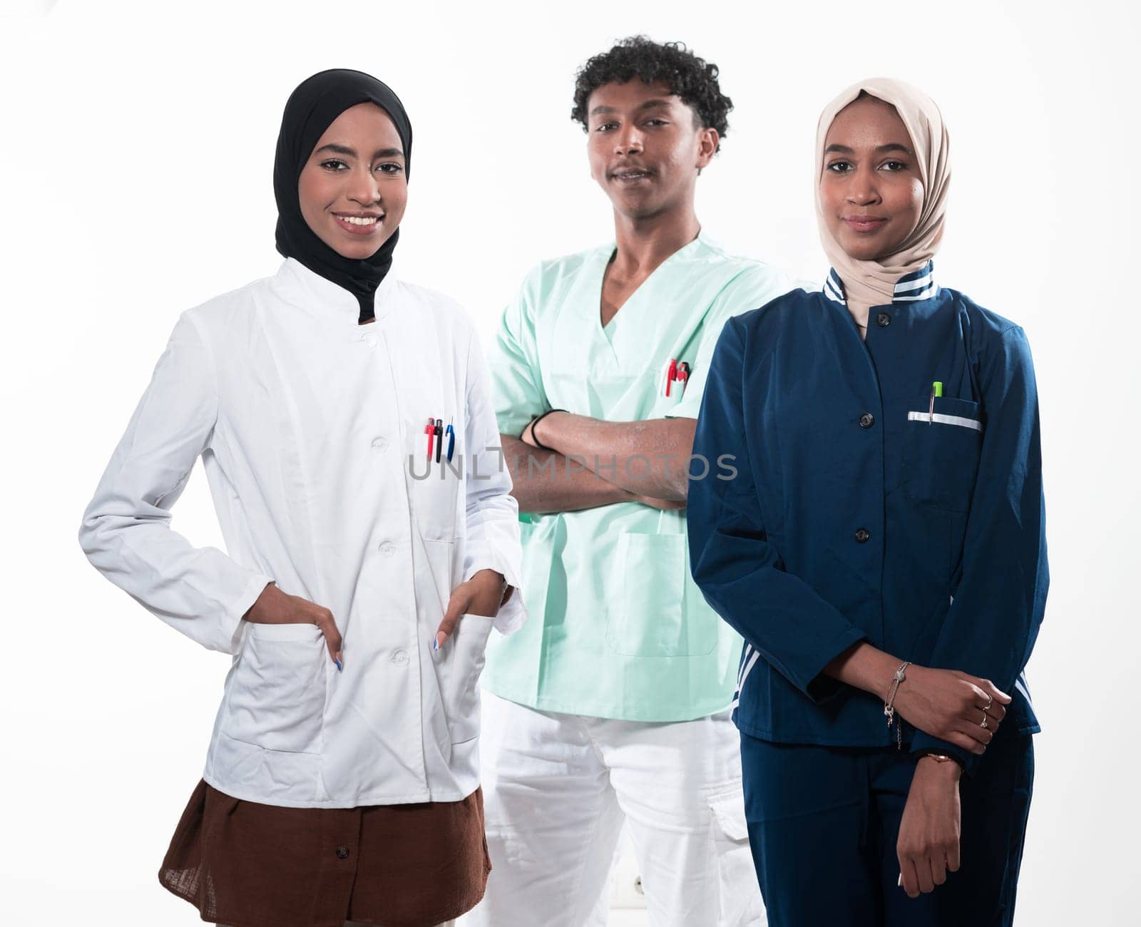 Closeup front view of group of mixed age doctors and nurses standing side by side and looking at the camera. Young Middle Eastern female in a team with African American male doctor. by dotshock