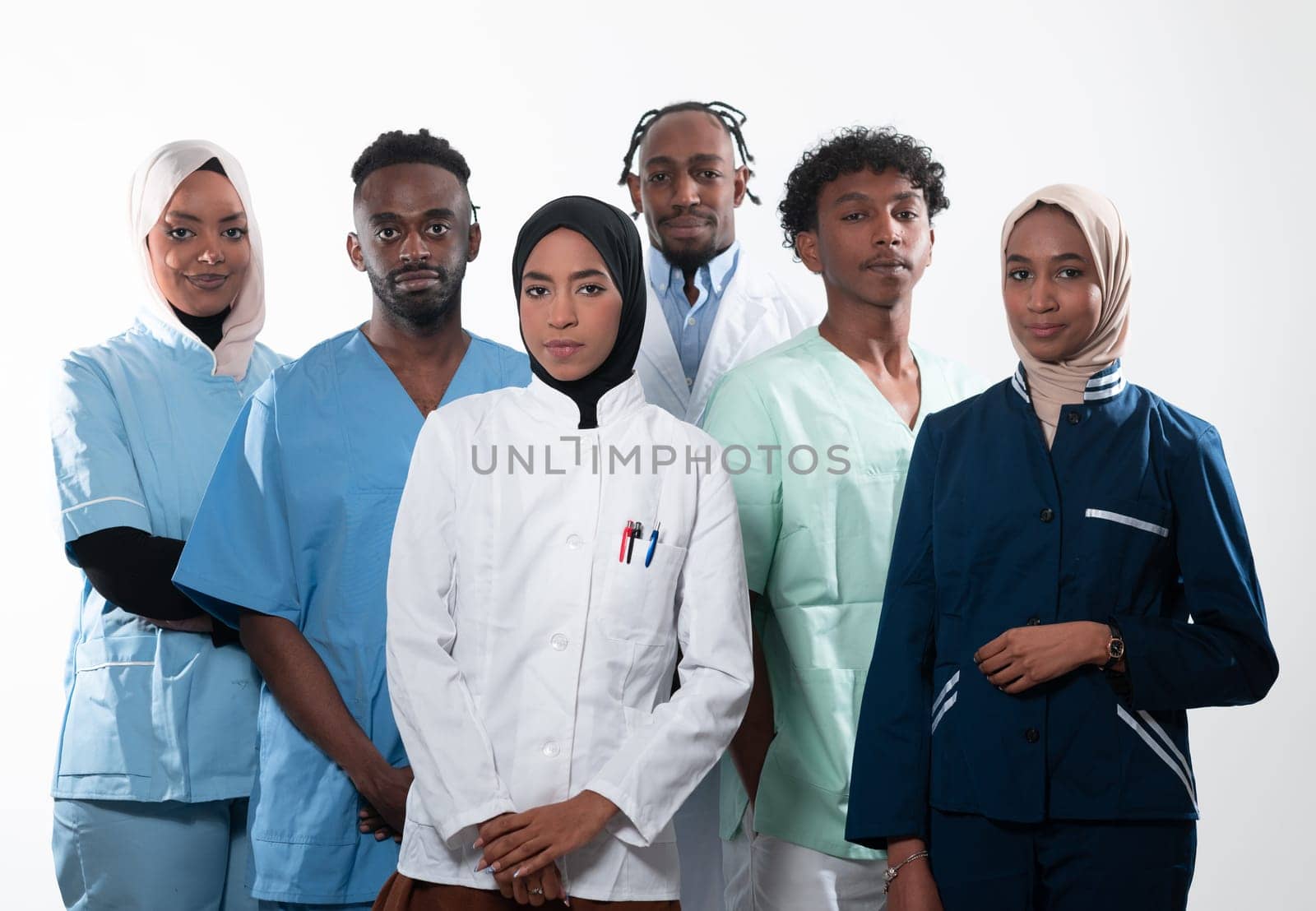 Team or group of a doctor, nurse and medical professional coworkers standing together. Portrait of diverse healthcare workers looking confident. Middle Eastern and African, Muslim medical team. High quality photo