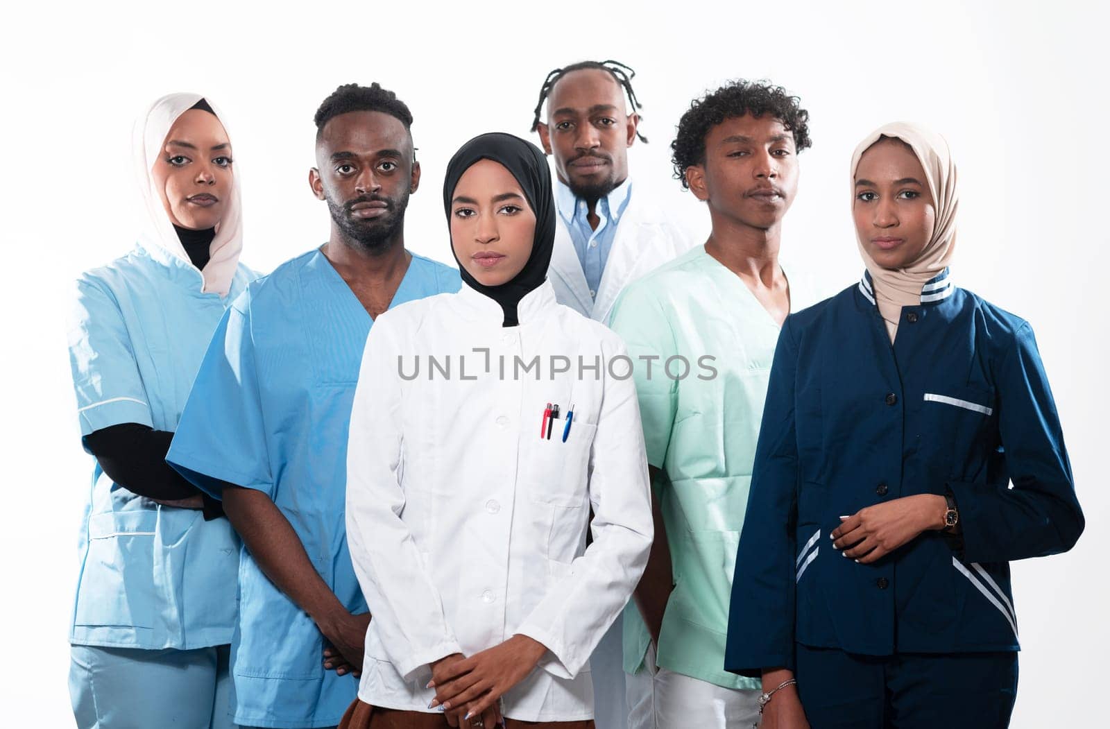 Team or group of a doctor, nurse and medical professional coworkers standing together. Portrait of diverse healthcare workers looking confident. Middle Eastern and African, Muslim medical team. High quality photo