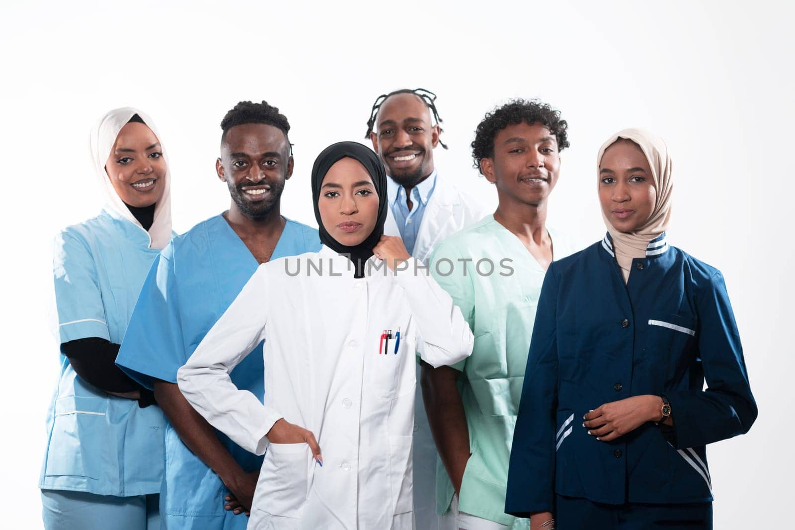 Team or group of a doctor, nurse and medical professional coworkers standing together. Portrait of diverse healthcare workers looking confident. Middle Eastern and African, Muslim medical team. High quality photo