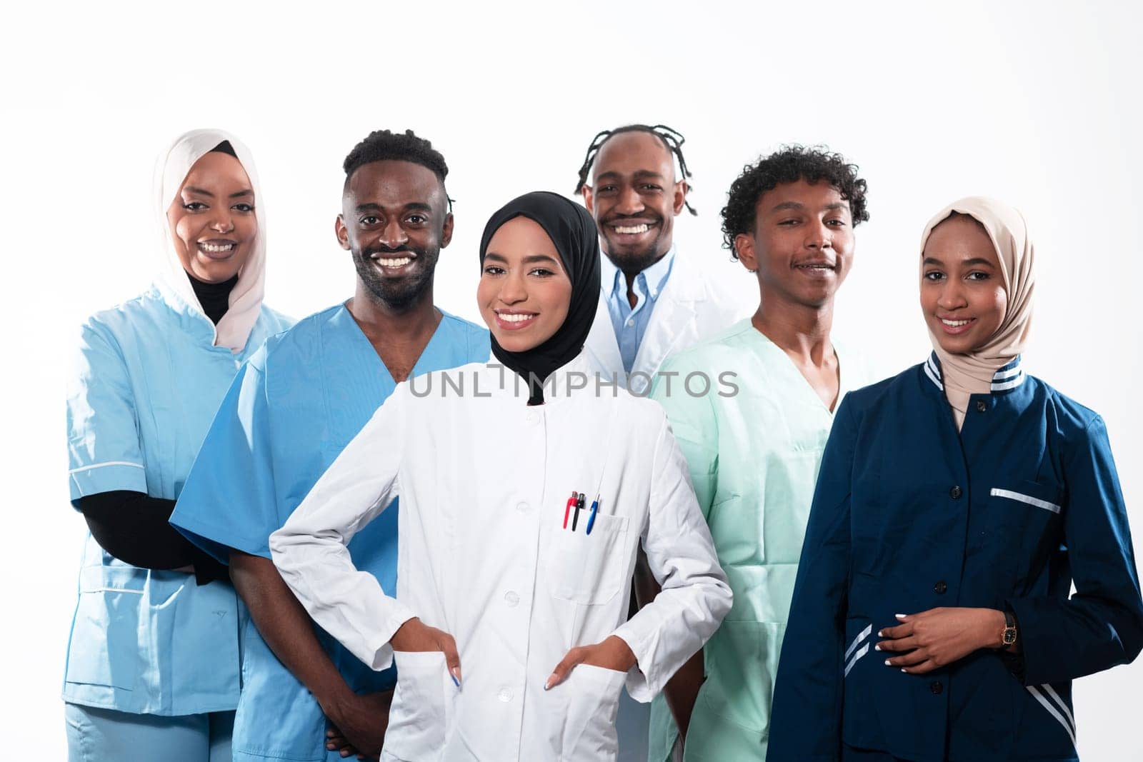 Team or group of a doctor, nurse and medical professional coworkers standing together. Portrait of diverse healthcare workers looking confident. Middle Eastern and African, Muslim medical team. High quality photo