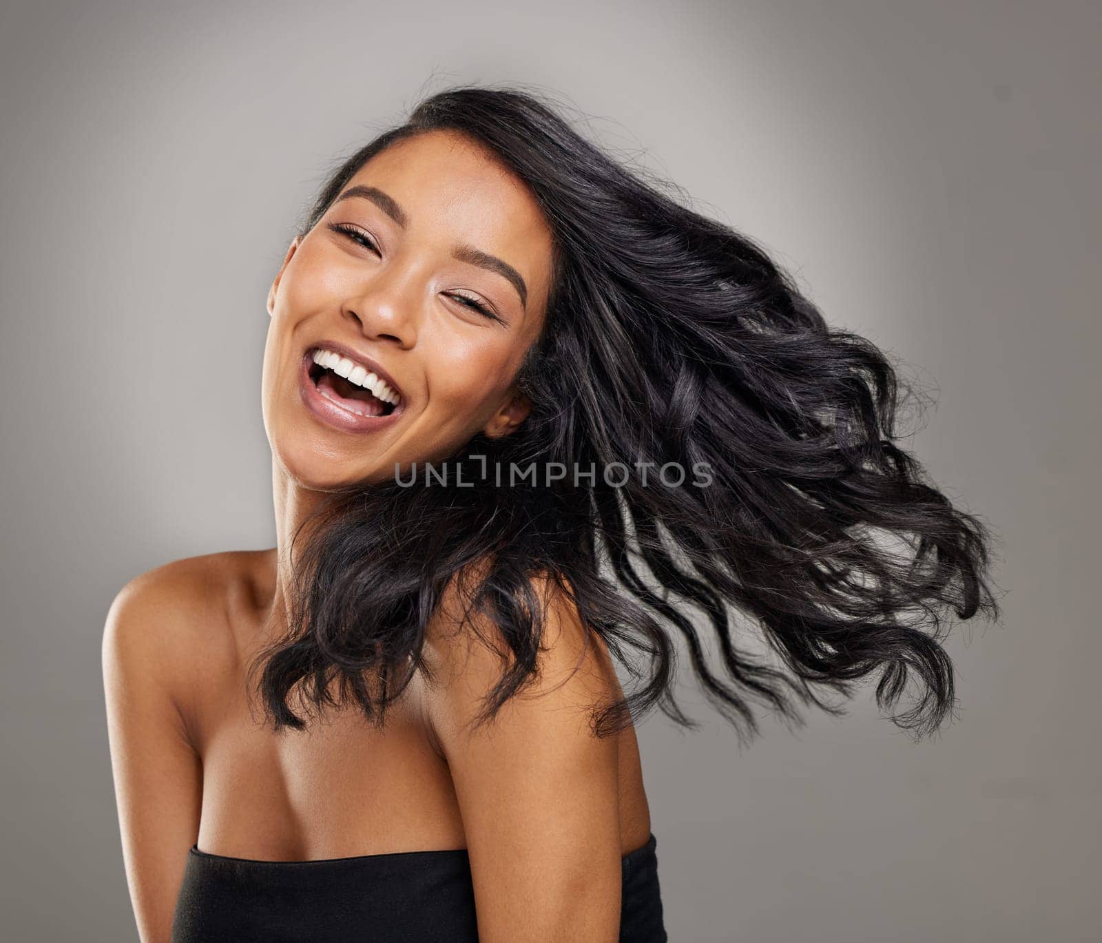 Hair, smile and portrait of happy woman in studio for cosmetics, treatment and shine on grey background. Happy, face and haircare for female model with volume, texture and keratin result satisfaction.