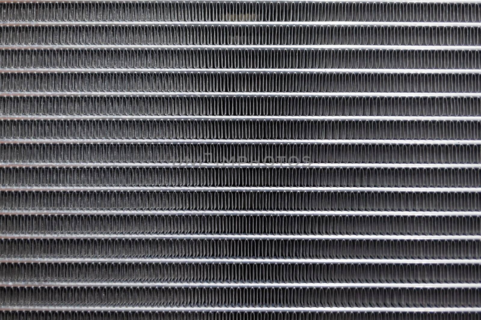 Texture of a car radiator. Engine cooler background. Vintage style. Radiator grille for car interior heater air conditioner, close-up. Radiator repair and replacement.