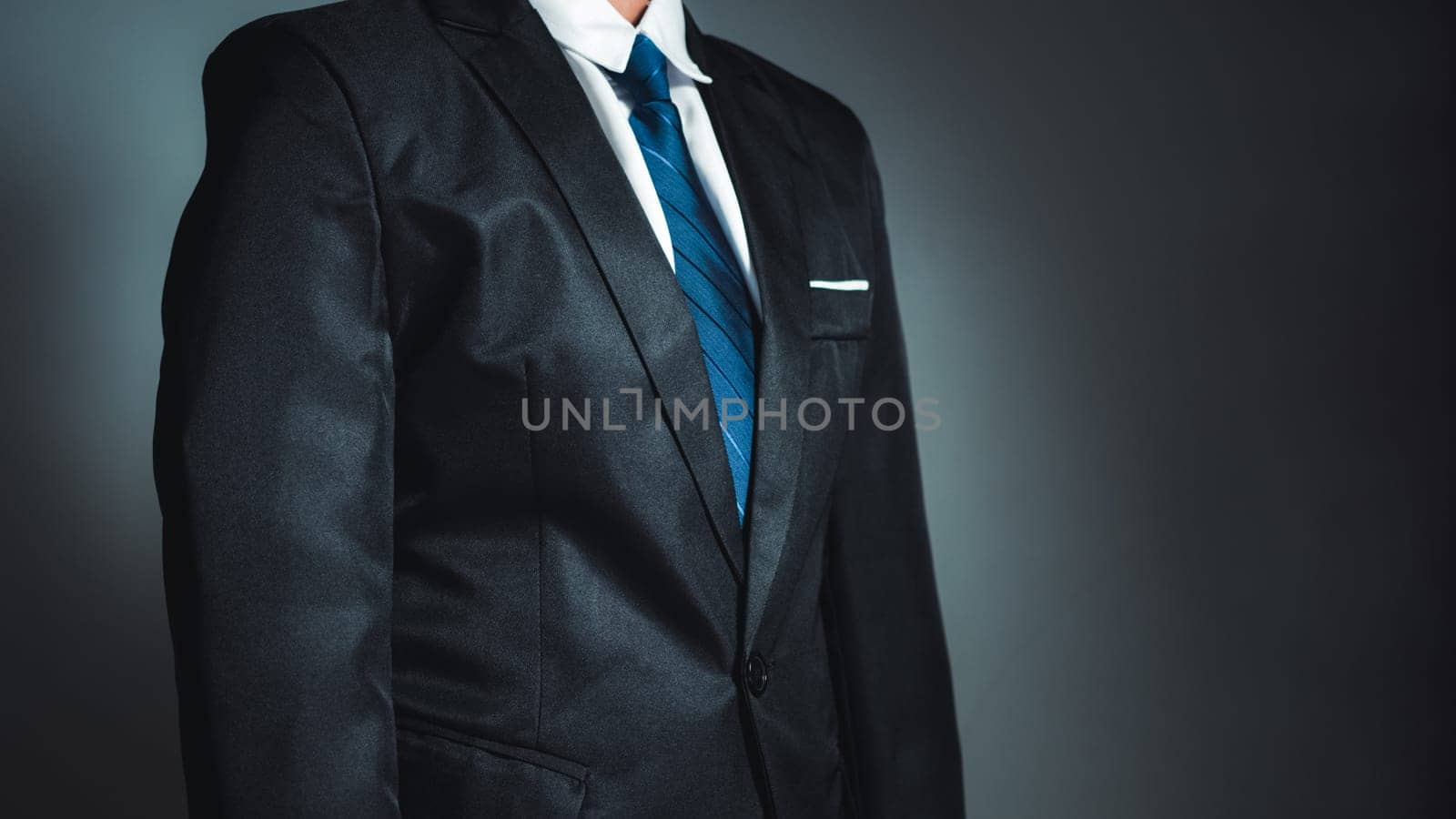 businessman standing on dark gradient background. business concept. suit.