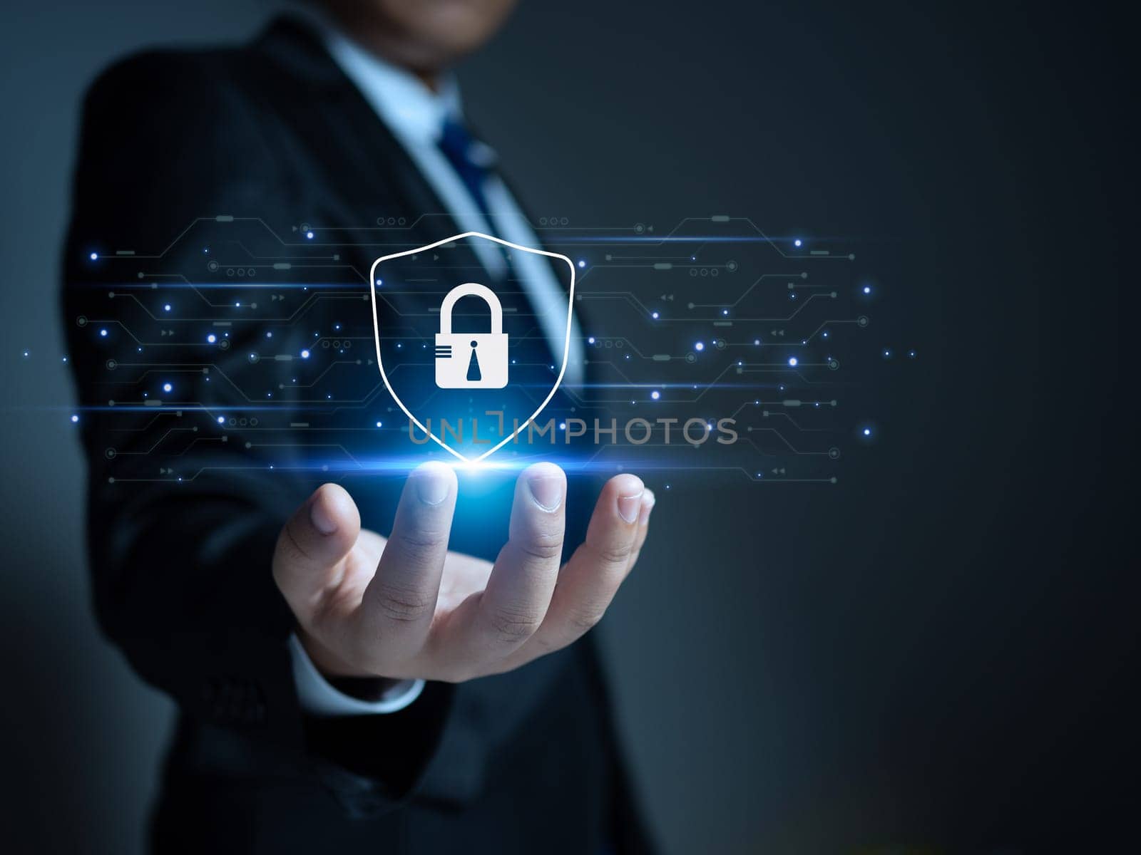 Businessman holding a protection sign. Represents protection against external hacks. Concepts of protection against code, viruses, firmware and malware.