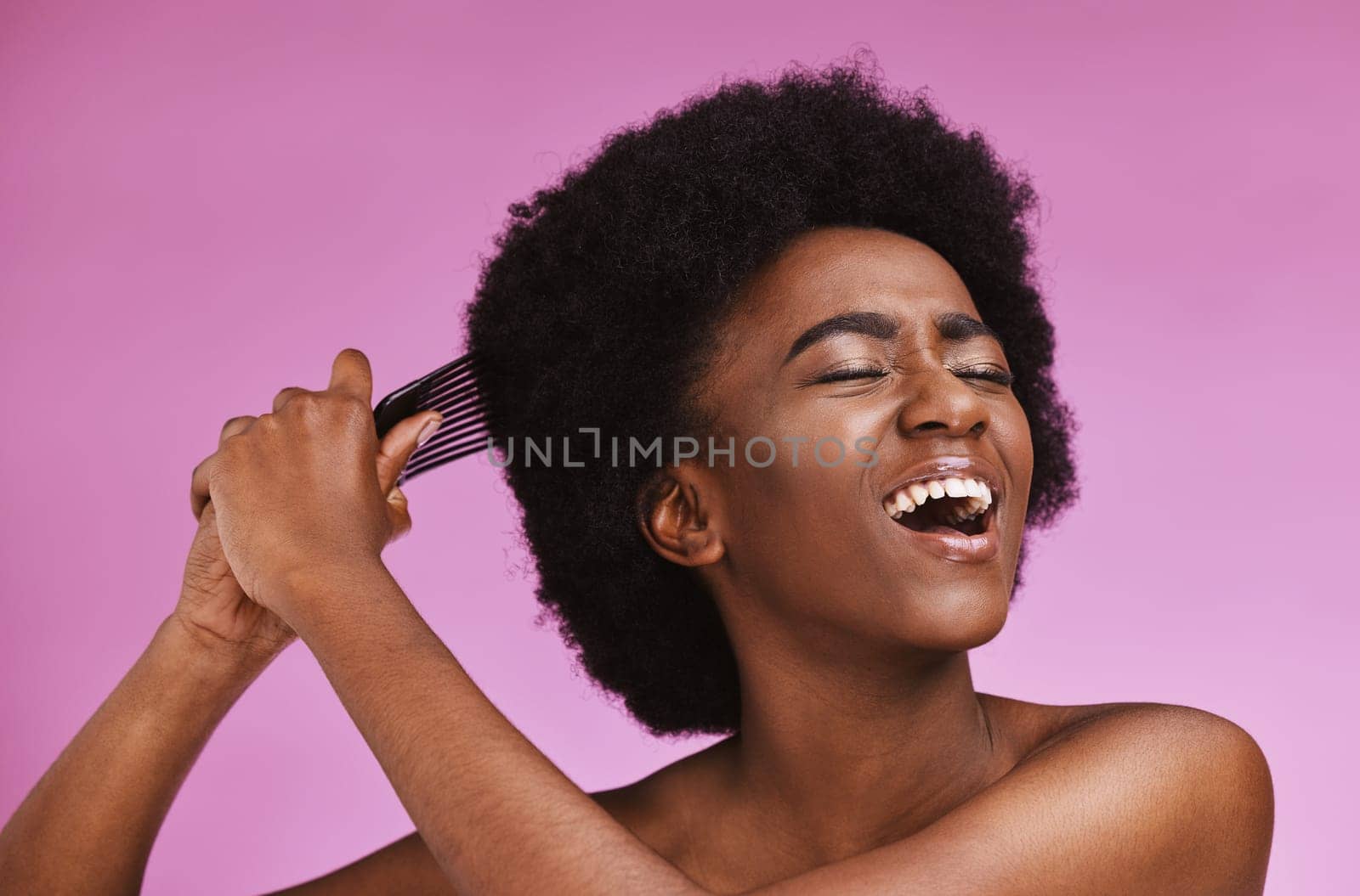 Stress, hairstyle and afro brushing on beauty studio background in grooming, texture anxiety or crisis. Black woman, comb and natural hair with damage, split ends or frizzy knots on isolated skincare.