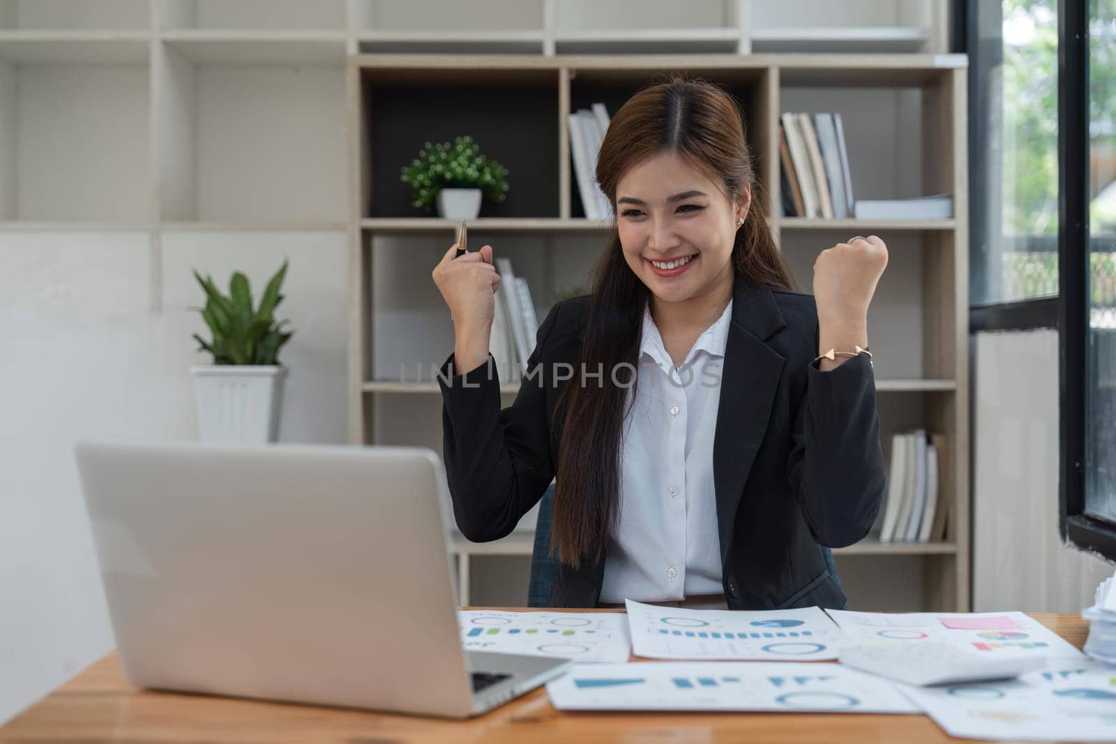 winner business woman with laptop, email announcement of promotion or bonus success. Excited corporate person with fist pump for office celebration, salary increase or target.