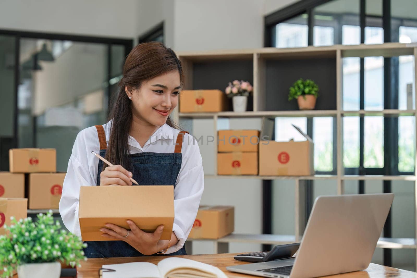 Business From Home Asian woman preparing package delivery box Shipping for shopping online. young start up small business owner at home online order.