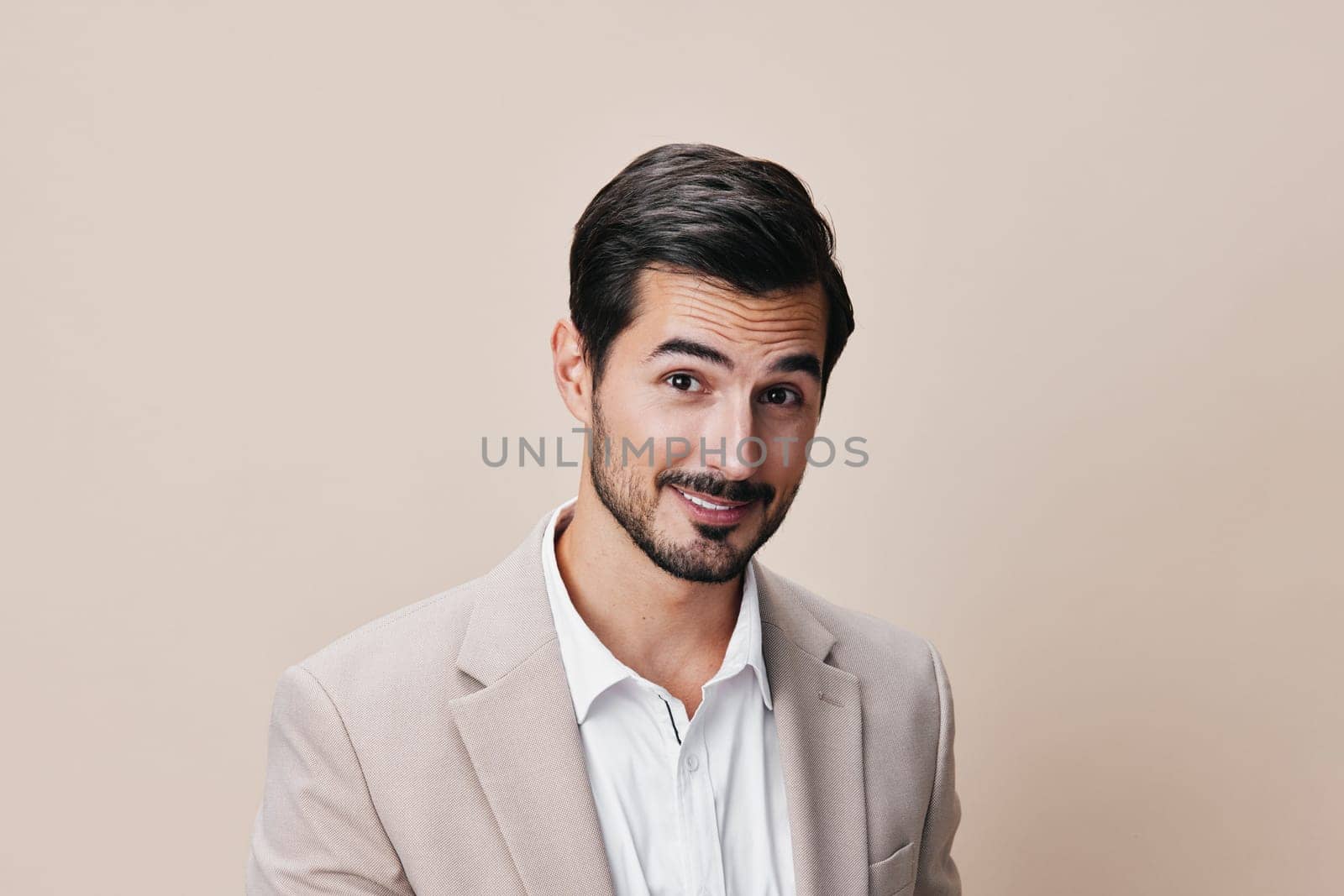 young man stylish portrait beard formal smiling corporate happy occupation successful white standing beige business suit handsome grey copyspace businessman fashion