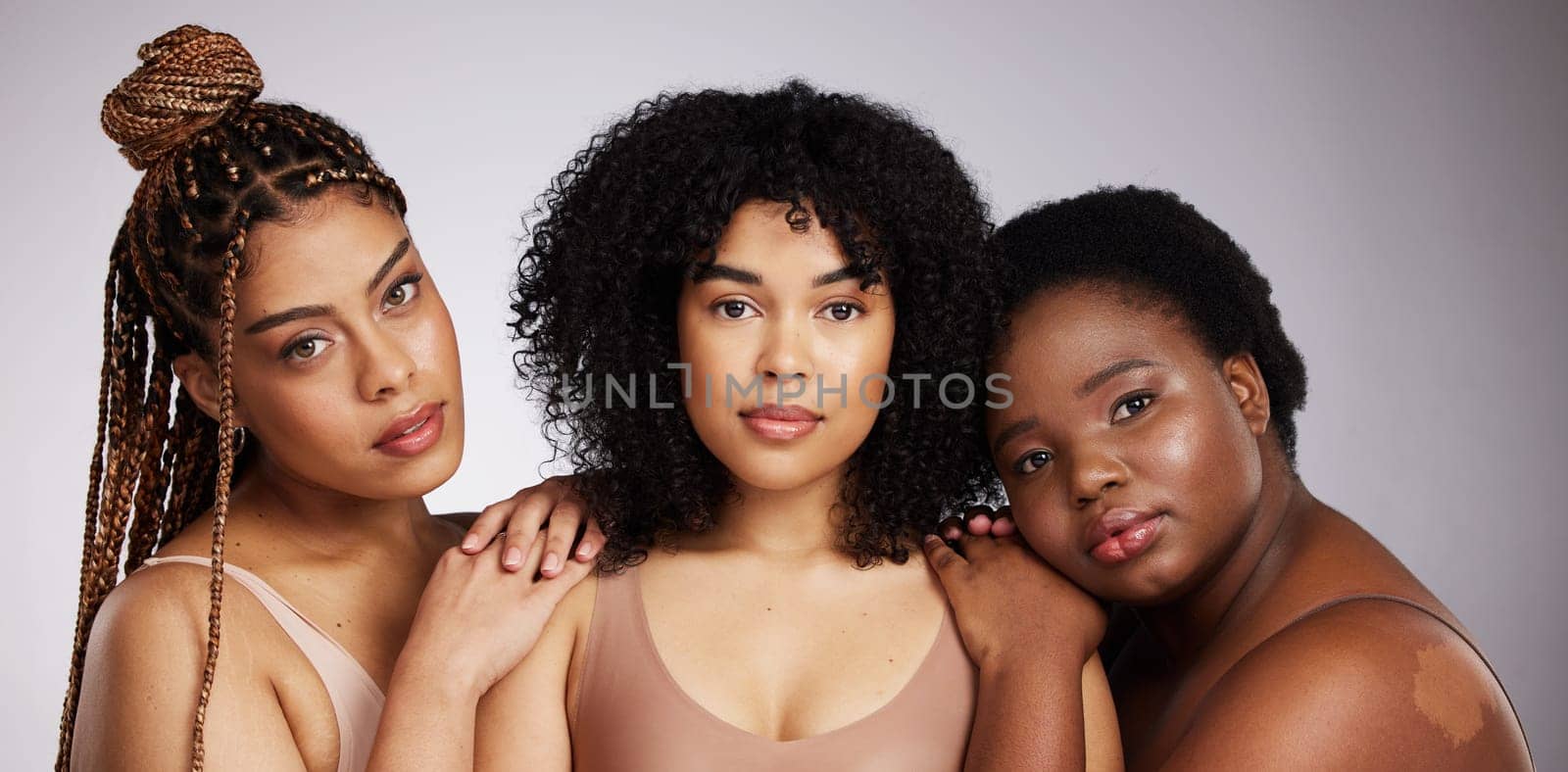 Portrait, skincare and diversity with woman friends in studio on a gray background together for beauty. Face, makeup and natural with a female model group posing to promote support or inclusion.