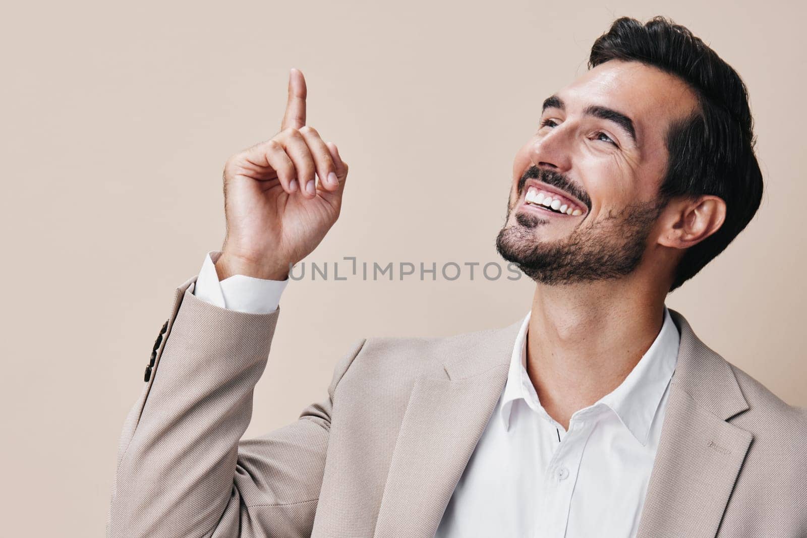 man businessman success winner victory arm beige business background suit male smile young celebrate cheerful person hand confident posing happy stylish