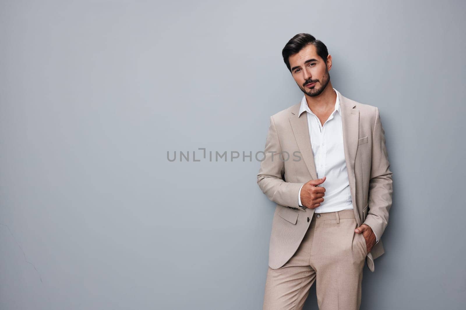 smiling man beige copyspace businessman happy suit business confident handsome portrait by SHOTPRIME