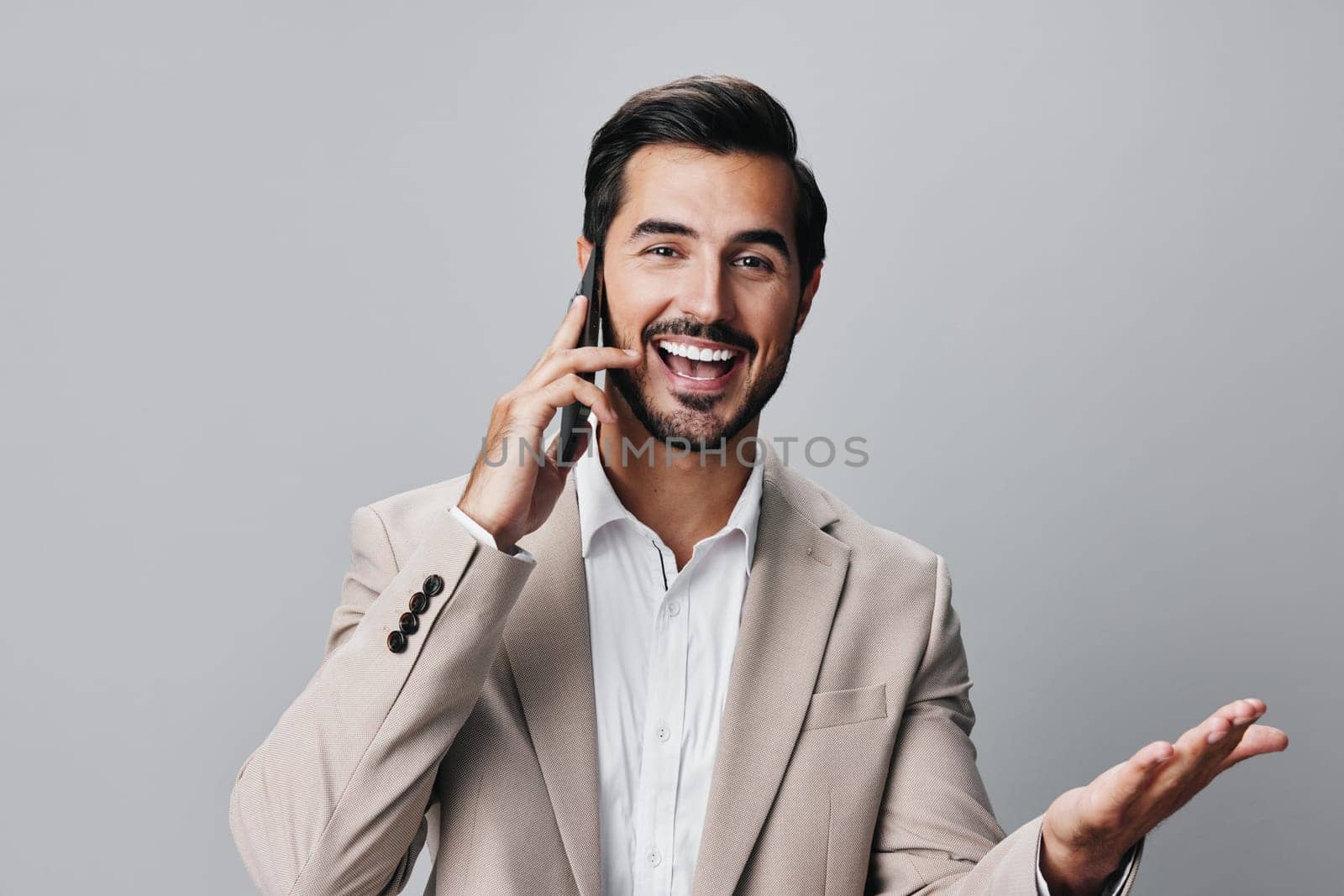 man communication cell studio hold selfies internet smile call isolated phone suit portrait smartphone adult message background gray trading business male happy