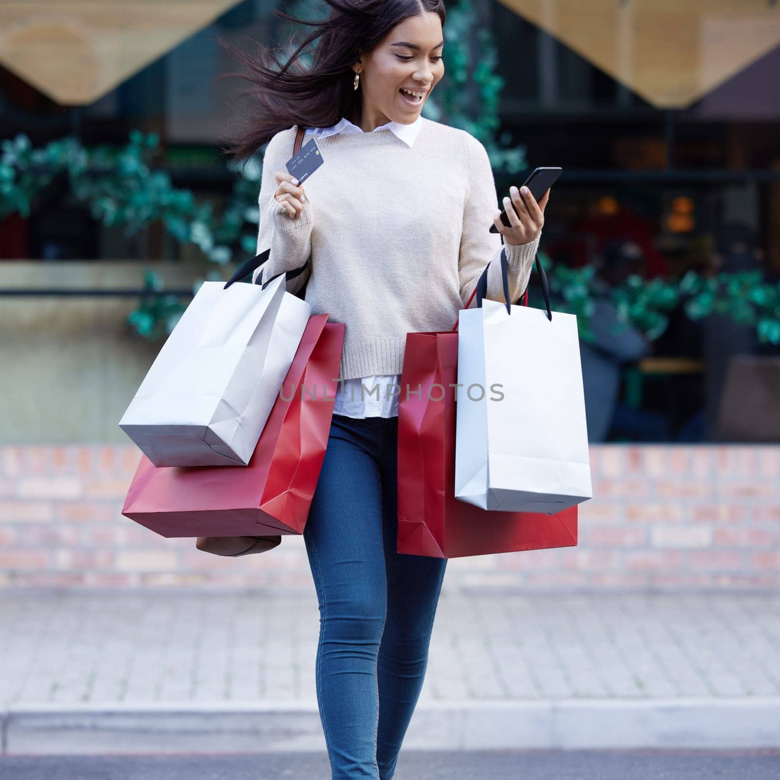 Phone, credit card and woman with shopping bags in city with posh, rich and luxury lifestyle. Fashion, young and female person walking in town after sale purchase from store and online retail shop