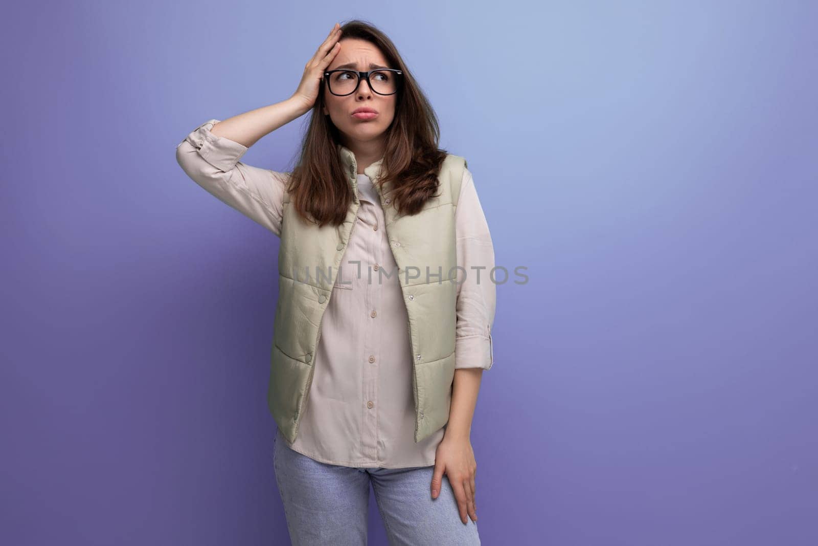 young brunette woman in casual look and glasses is having a headache by TRMK