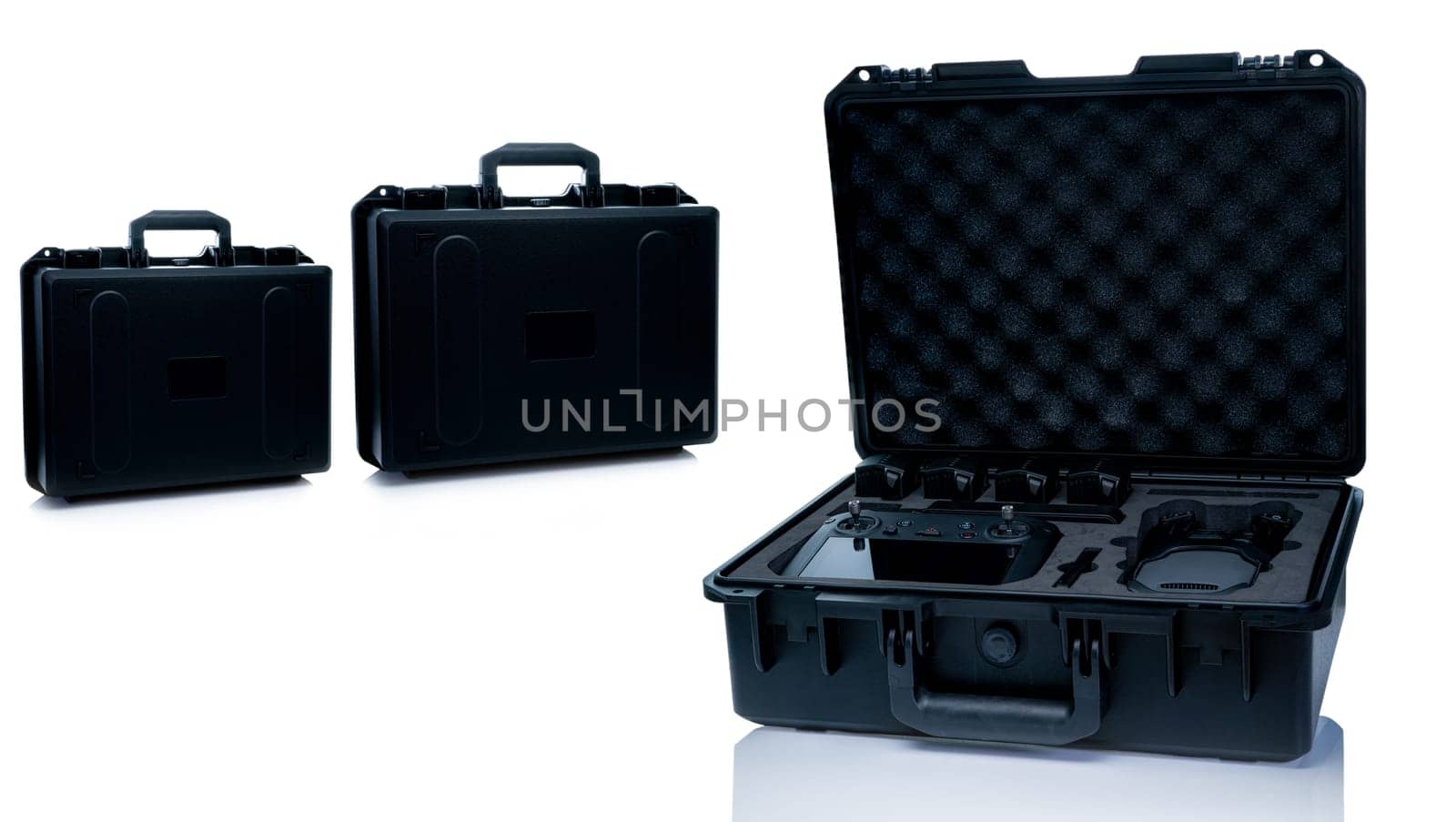 Drone and accessories in plastic case isolated on white background. UAV or unmanned aerial vehicle and drone accessories in protective travel case. LiPo rechargeable battery in storage container. by Fahroni