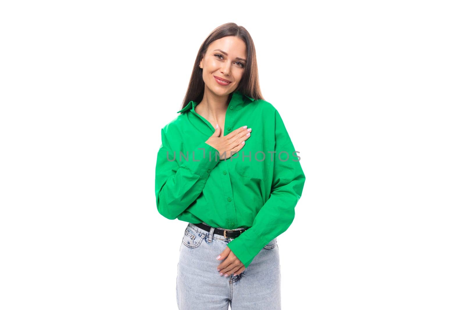 pretty well-groomed brunette long-haired young woman in a green shirt on a white background with copy space by TRMK