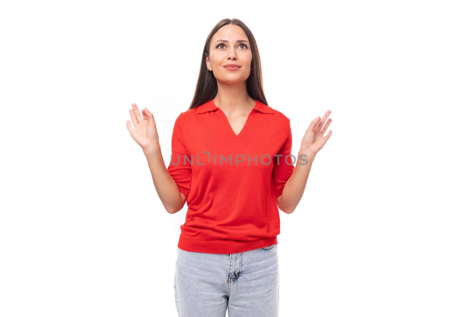 portrait of a charming cute young european brunette lady in a red t-shirt on a white background with copy space.