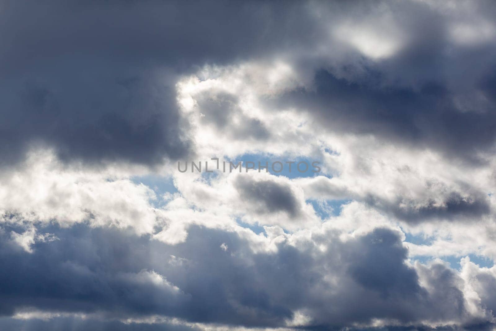 Big white clouds in a blue sky close-up. There is a place for the text by AnatoliiFoto